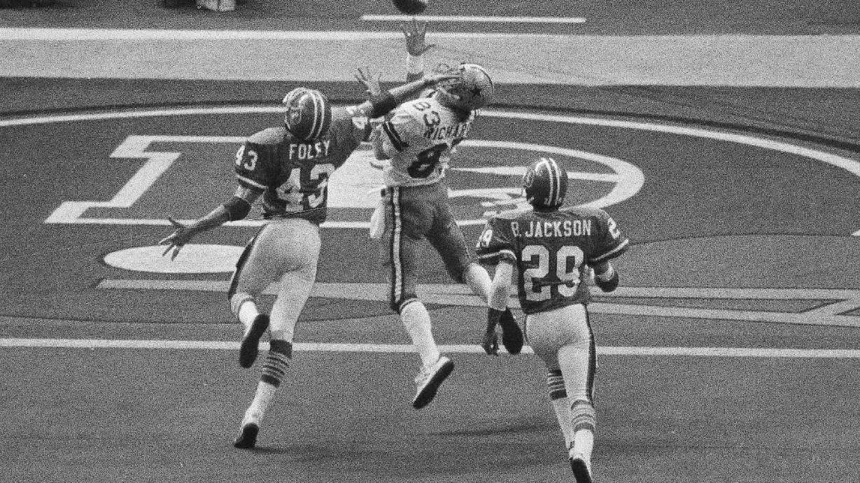 FILE - Despite the effort of Denver Broncos defensive back Steve Foley (43), Dallas Cowboys wide receiver Golden Richards hauls in a touchdown pass during NFL football's Super Bowl 12 in New Orleans on Jan 15, 1978. Richards died Friday, Feb. 23, 2024, of congestive heart failure at his home in Murray, Utah. He was 73. Richards' nephew Lance Richards confirmed his death in a post on his Facebook page.