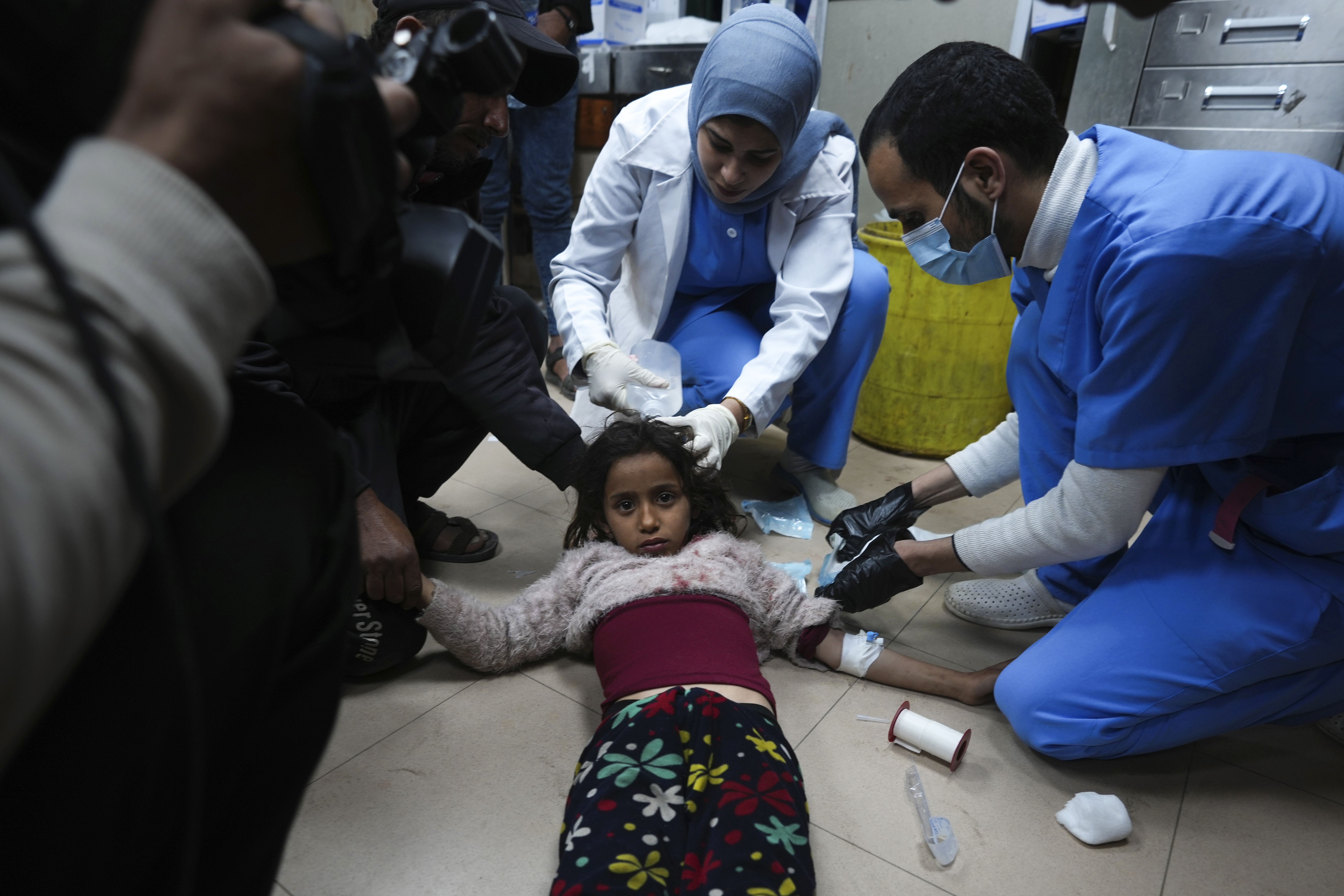 Palestinians wounded in the Israeli bombardment of the Gaza Strip are brought to Al Aqsa hospital in Deir al Balah, Friday.