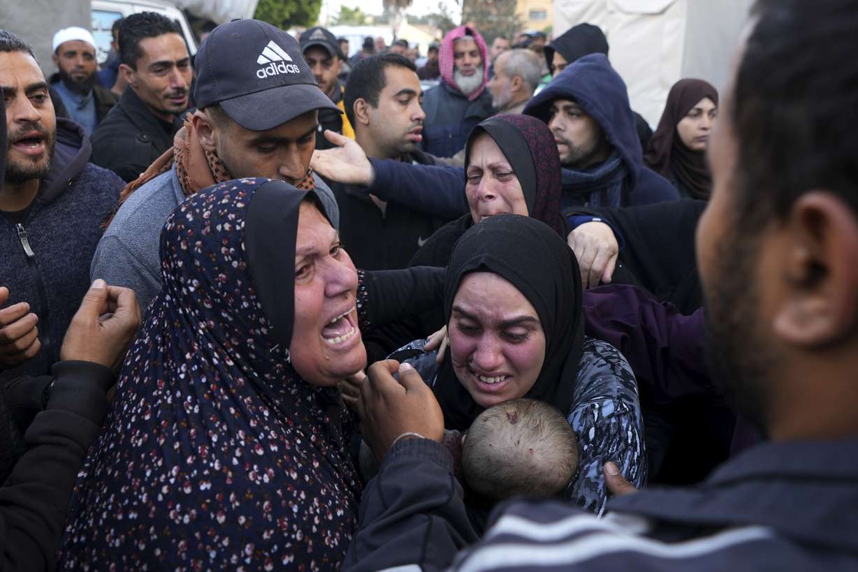 Palestinians mourn a baby killed in the Israeli bombardments of the Gaza Strip in front of the morgue of the Al Aqsa Hospital in Deir al Balah on Saturday.