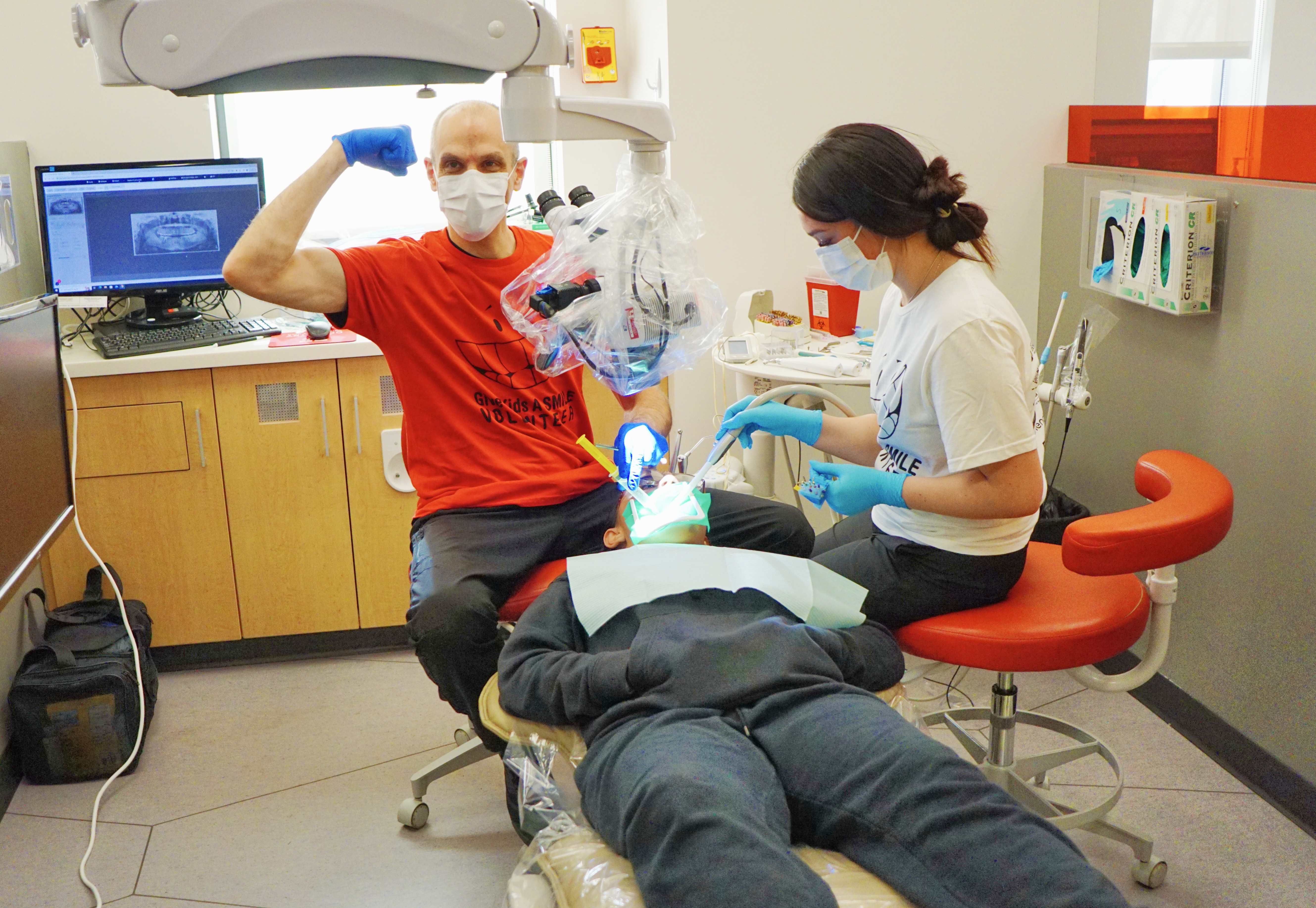 A volunteer dentist and a University of Utah dental student perform an examination during the "Give A Kid A Smile" event at the U. in Salt Lake City on Saturday.