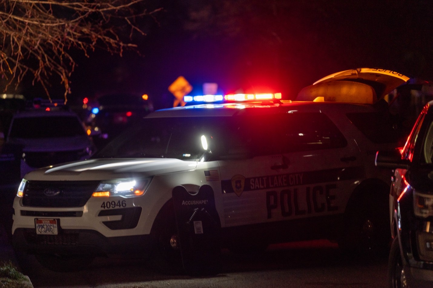 A Salt Lake City Police car blocks 600 East near 2500 South while patrol and SWAT officers attempt to safely take a suspect into custody.