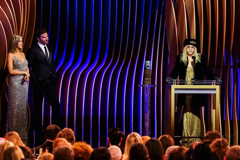 Barbra Streisand receives the SAG Life Achievement Award as Jennifer Aniston and Bradley Cooper looks on during the 30th Screen Actors Guild Awards, in Los Angeles, California, U.S., Feb. 24.