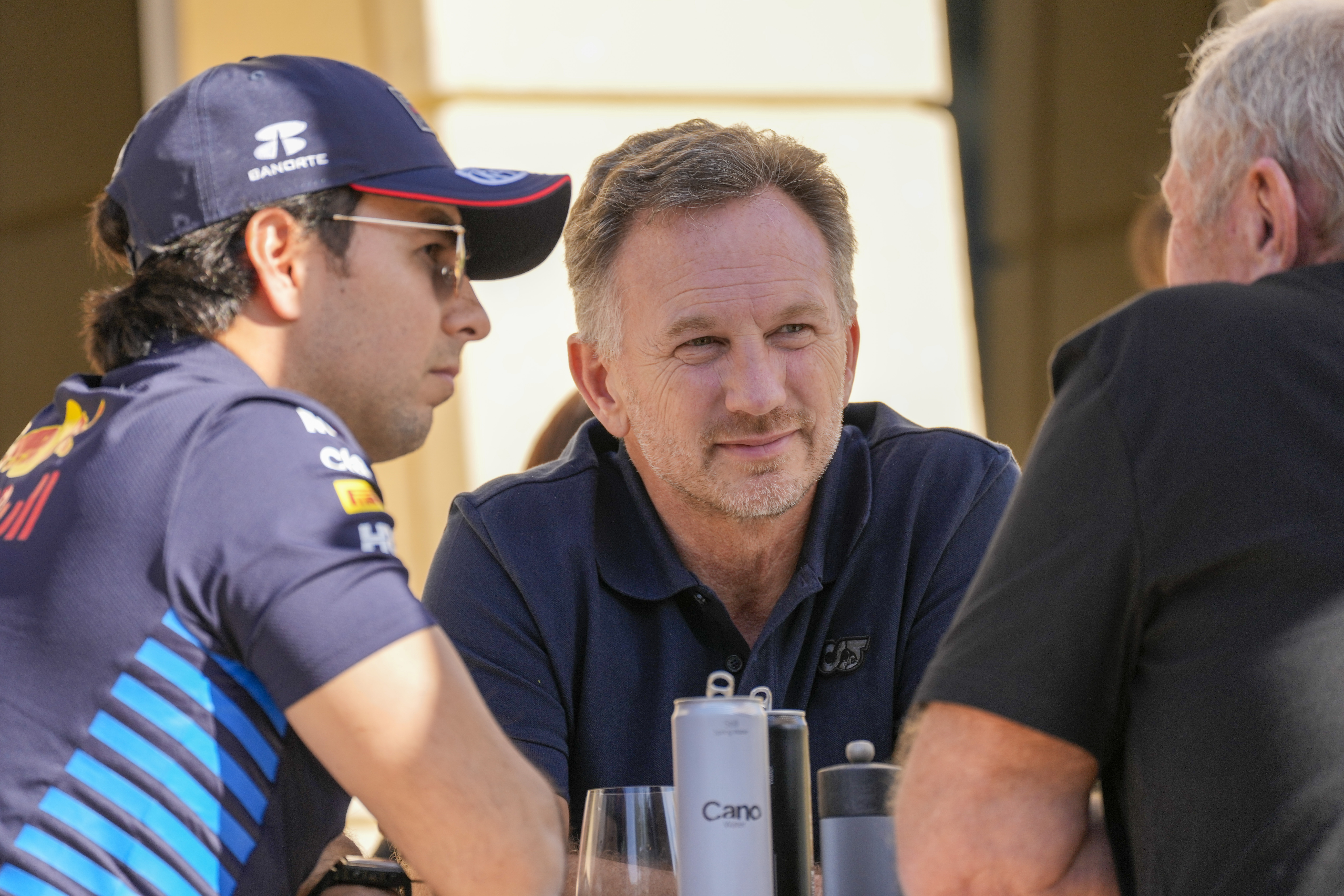 Red Bull team principal Christian Horner, centre, chats with Red Bull driver Sergio Perez of Mexico, left, and Helmut Marko, director of the Red Bull Formula One teams, right, at the pits during Formula One pre season test at the Bahrain International Circuit in Sakhir, Bahrain, Wednesday, Feb. 21, 2024. 