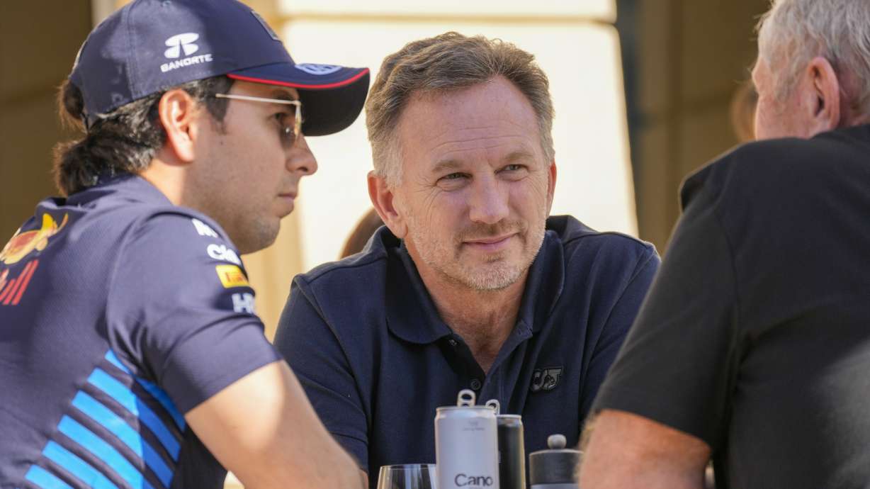 Red Bull team principal Christian Horner, centre, chats with Red Bull driver Sergio Perez of Mexico, left, and Helmut Marko, director of the Red Bull Formula One teams, right, at the pits during Formula One pre season test at the Bahrain International Circuit in Sakhir, Bahrain, Wednesday, Feb. 21, 2024.
