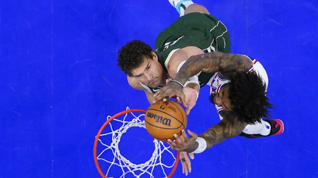 Philadelphia 76ers' Kelly Oubre Jr., right, goes up for a shot against Milwaukee Bucks' Brook Lopez during the first half of an NBA basketball game, Sunday, Feb. 25, 2024, in Philadelphia.