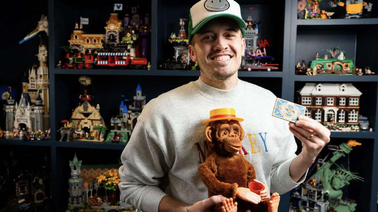 Tanner Yarro holds a vintage toy he found on eBay and a vintage-inspired Diceomatic Dice Spinner in his home office in Provo on Thursday.