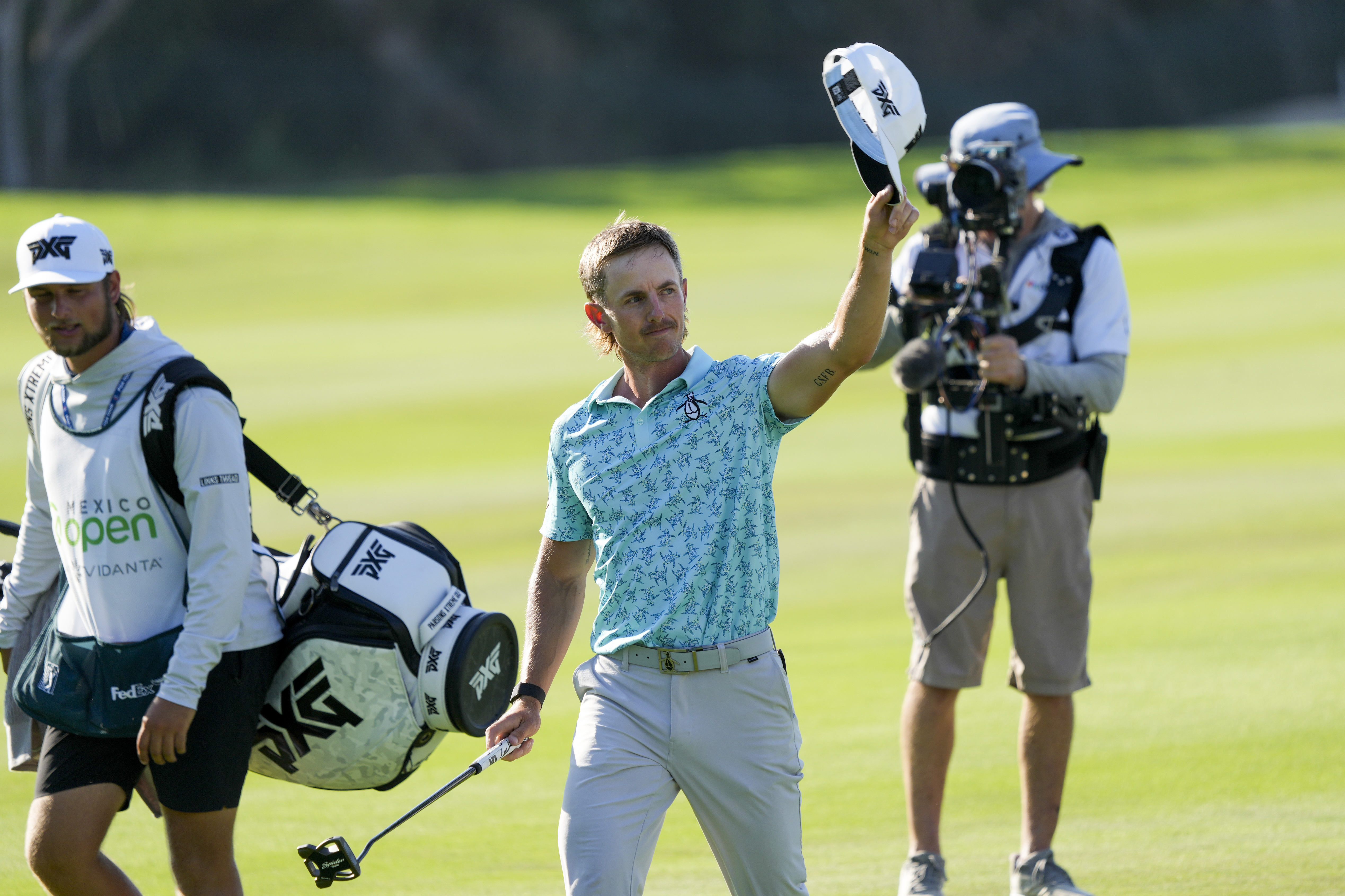 Jake Knapp, of the United States, greets fans as he arrives to 18th hole during the final round of the Mexico Open golf tournament in Puerto Vallarta, Mexico, Sunday, Feb. 25, 2024. 