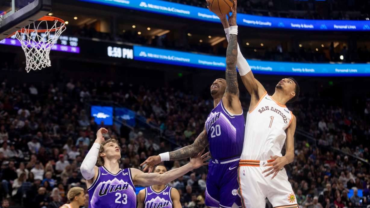 Utah Jazz forward John Collins (20) jumps to block San Antonio Spurs center Victor Wembanyama’s (1) shot during a game at the Delta Center in Salt Lake City on Sunday, Feb. 25, 2024.