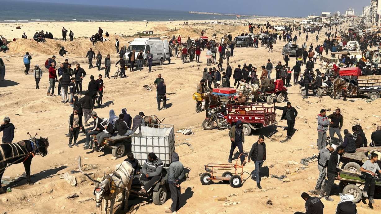 Palestinians wait for humanitarian aid on a beachfront in Gaza City, Gaza Strip, Sunday. President Joe Biden says he hopes a cease-fire between Israel and Hamas this weekend.
