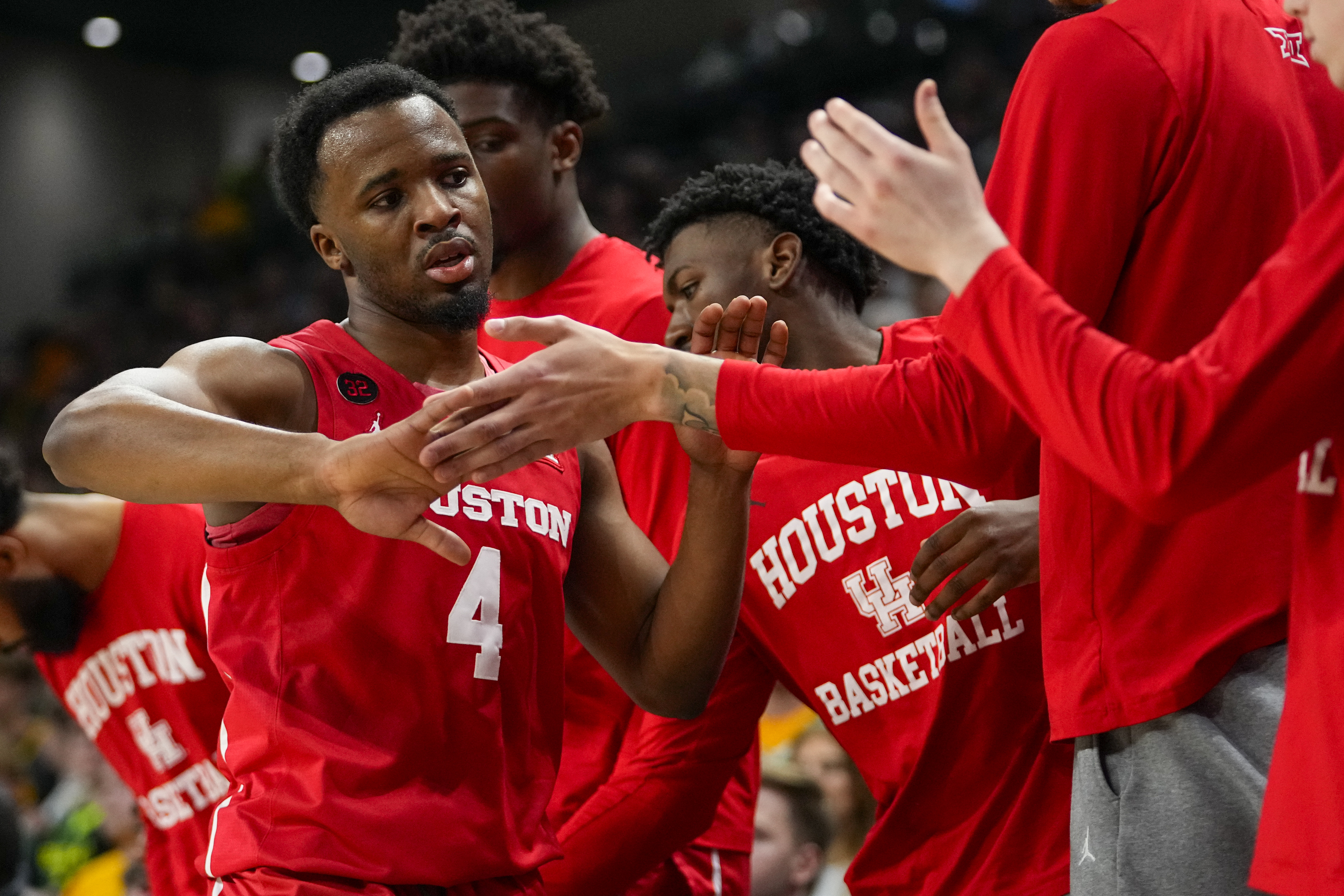 Houston guard L.J. Cryer (4) is greeted at the bench by teammates during the first half of an NCAA college basketball game against Baylor, Saturday, Feb. 24, 2024 in Waco, Texas.