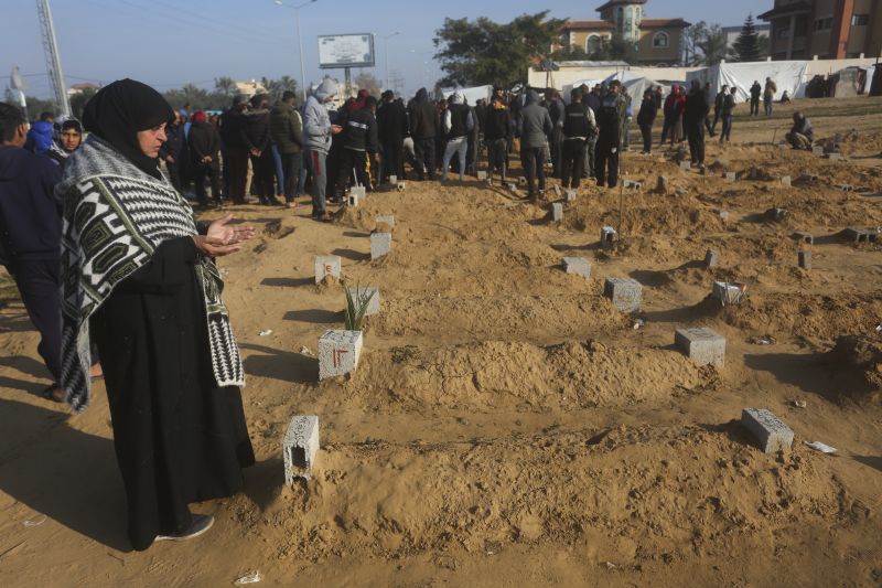 A Palestinian woman prays for a relative killed in the Israeli bombardment of the Gaza Strip in Khan Younis on Monday.