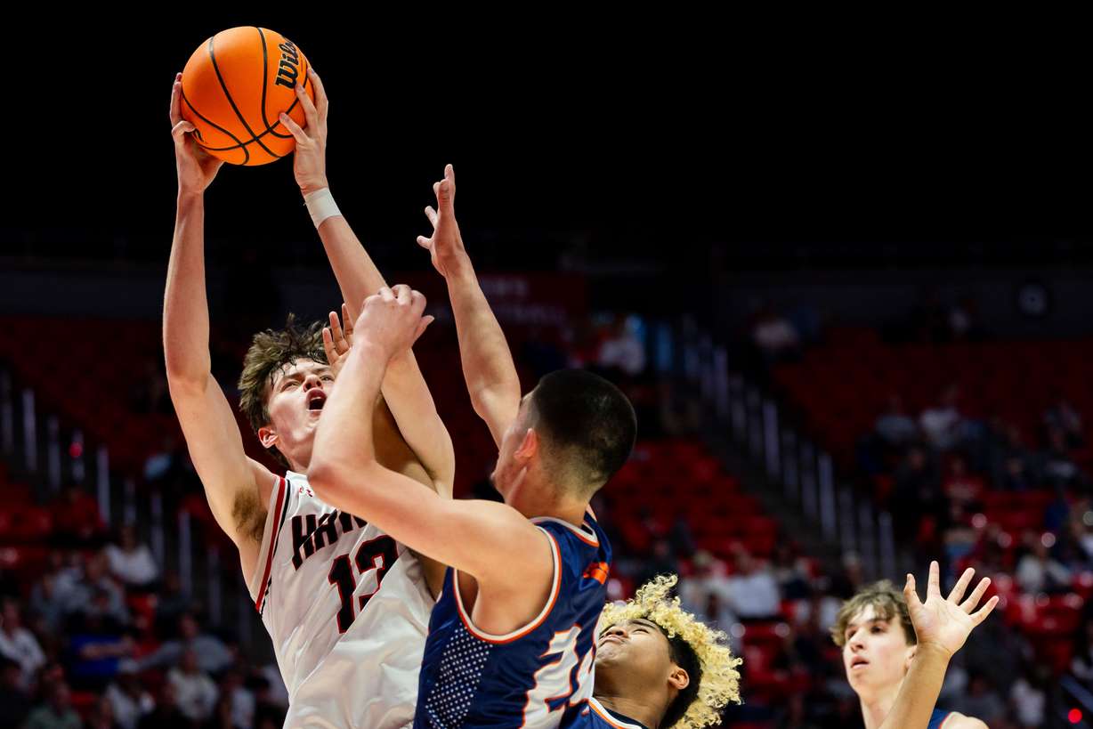 Alta’s Jaxon Johnson shoots the ball with Brighton’s Jaxon Soto on defense in the quarterfinals for 5A high school boys basketball at the Jon M. Huntsman Center in Salt Lake City on Saturday, Feb. 24, 2024.