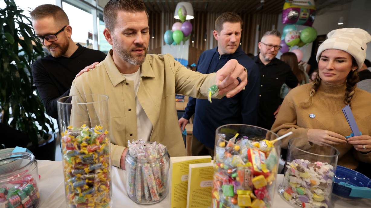 Nate Randle, Gabb CEO, reaches for candy at a smartphone detox kickoff event at the Gabb office in Lehi on Thursday. The company known for making smartphones for kids kicked off its own employee-wide phone detox during an event on Thursday.