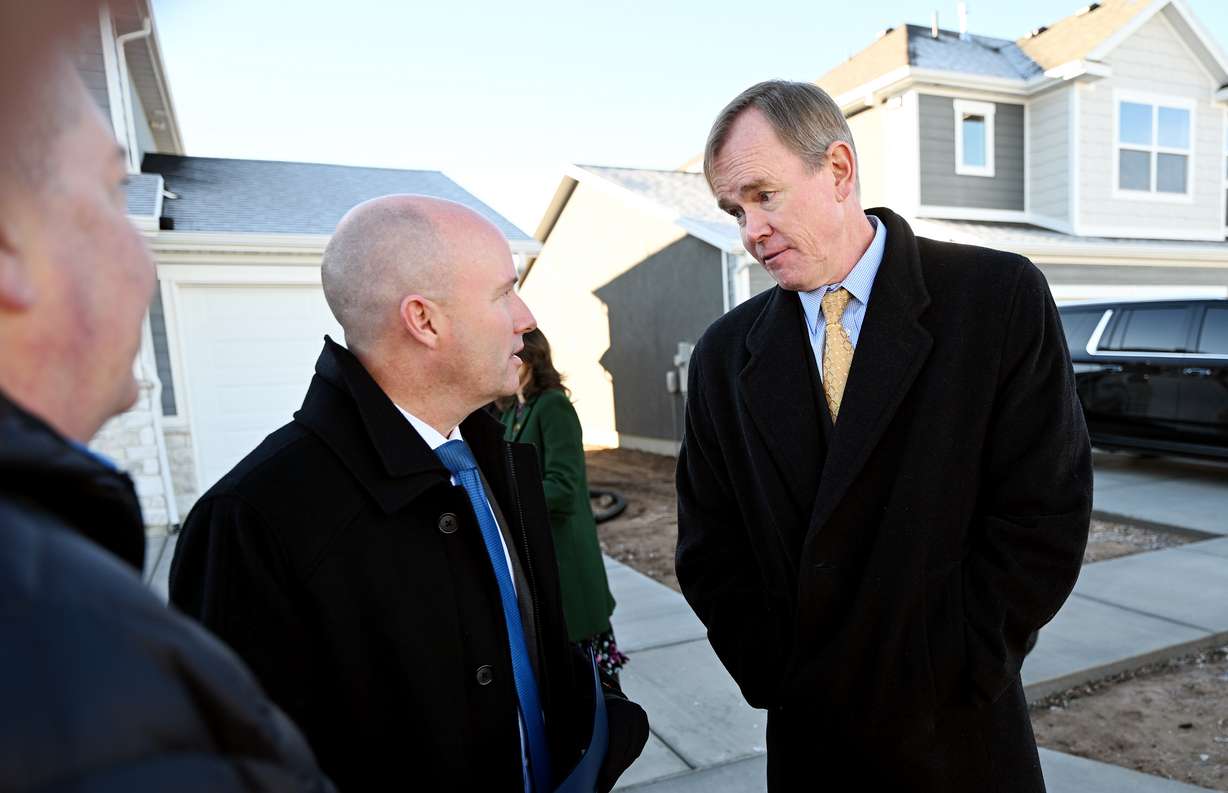 Gov. Spencer Cox talks with Steve Waldrip, senior adviser for housing strategy and innovation, in West Haven on Dec. 5, 2023. Waldrip said Wednesday the influx of people coming into the state has made it harder to buy a home.