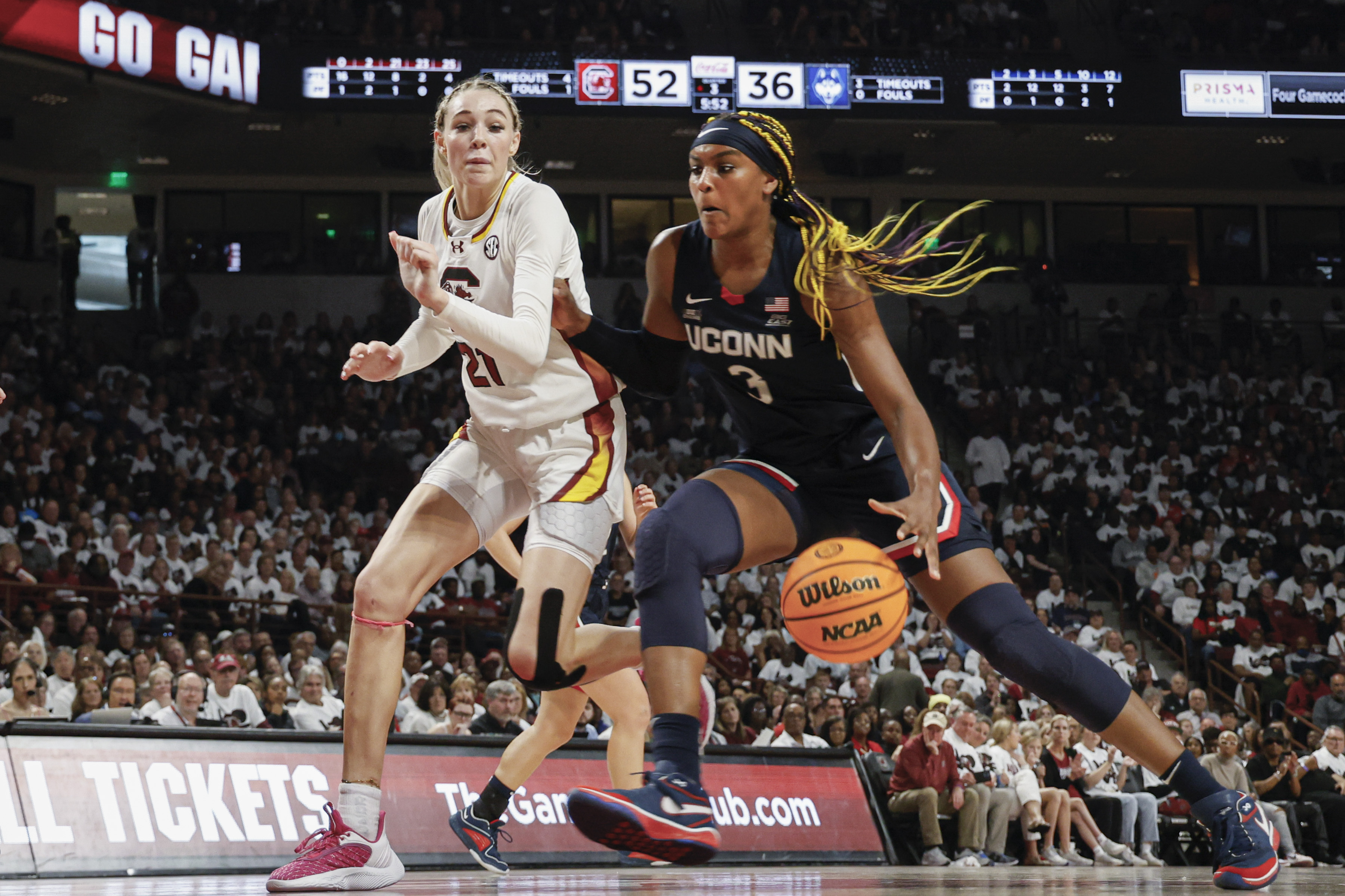 UConn forward Aaliyah Edwards, right, drives to the basket against South Carolina forward Chloe Kitts, left, during the second half of an NCAA college basketball game in Columbia, S.C., Sunday, Feb. 11, 2024. 