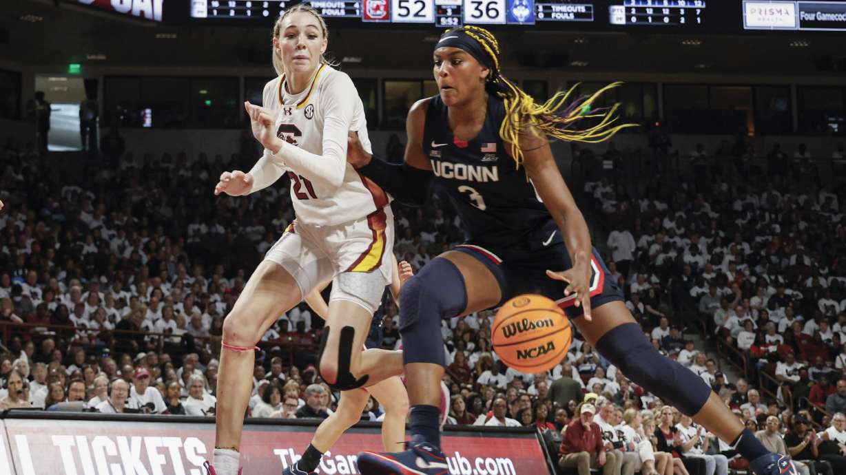 UConn forward Aaliyah Edwards, right, drives to the basket against South Carolina forward Chloe Kitts, left, during the second half of an NCAA college basketball game in Columbia, S.C., Sunday, Feb. 11, 2024.