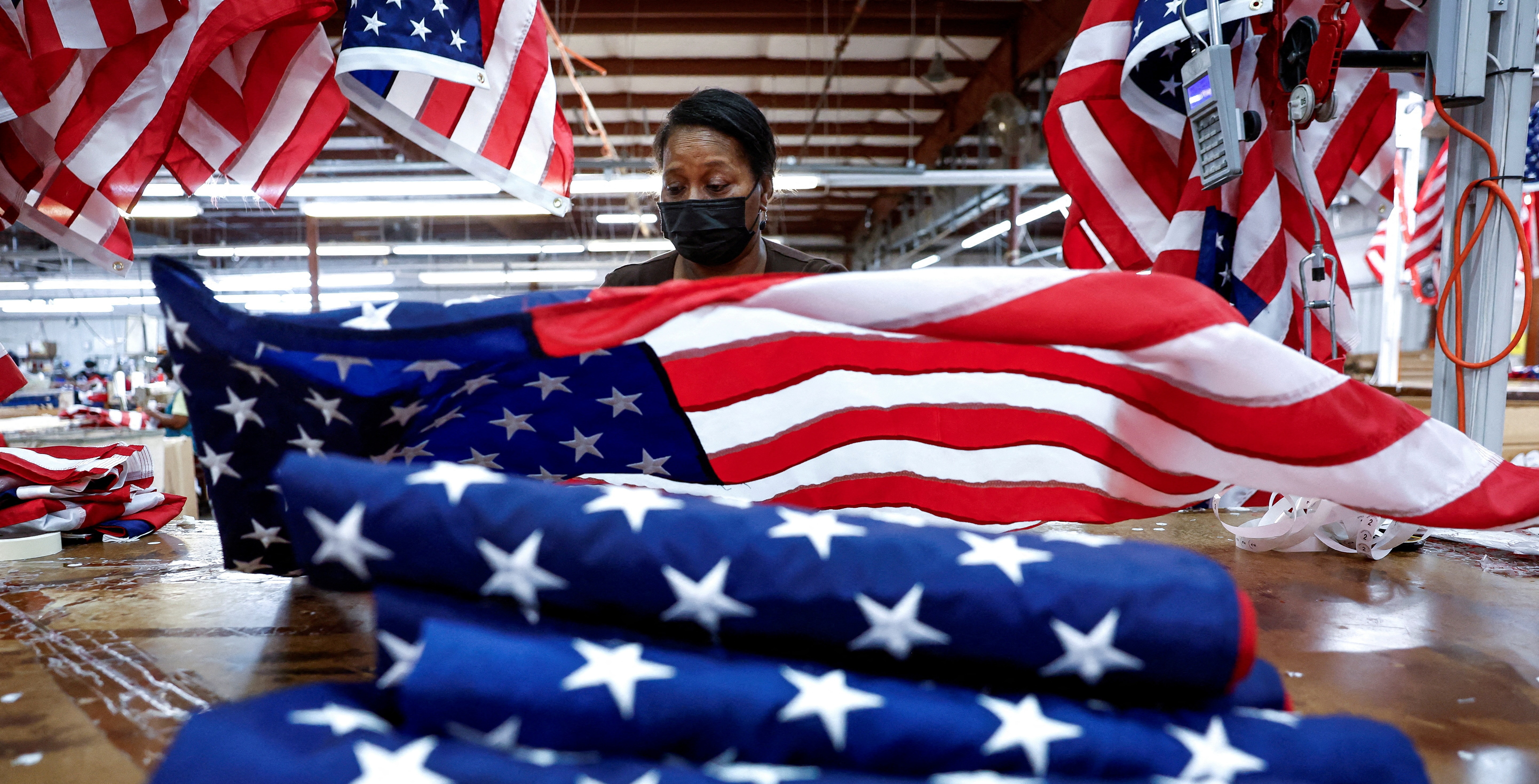 Barbara McClorin inspects U.S. flags made at Valley Forge Flag’s manufacturing facility in Lane, S.C., Thursday. A new poll reveals concerns about political extremism and threats to democracy.