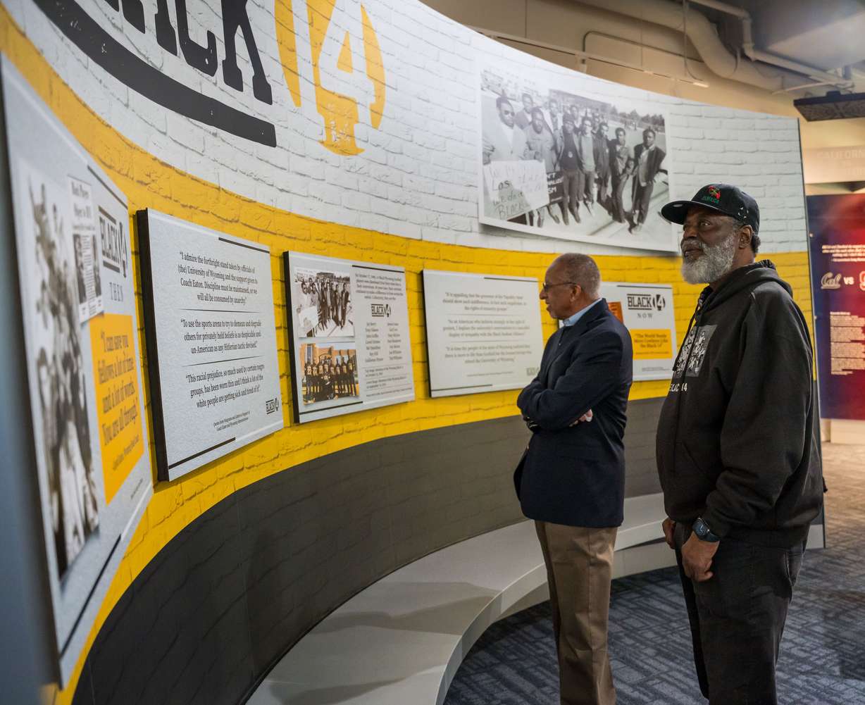 John Griffin, left, and Tony McGee look at the Black 14 exhibit, unveiled Feb. 5, 2024, at the College Football Hall of Fame. They are among the Black 14, the members of the University of Wyoming football team dismissed in 1969 after broaching the idea of a protest.
