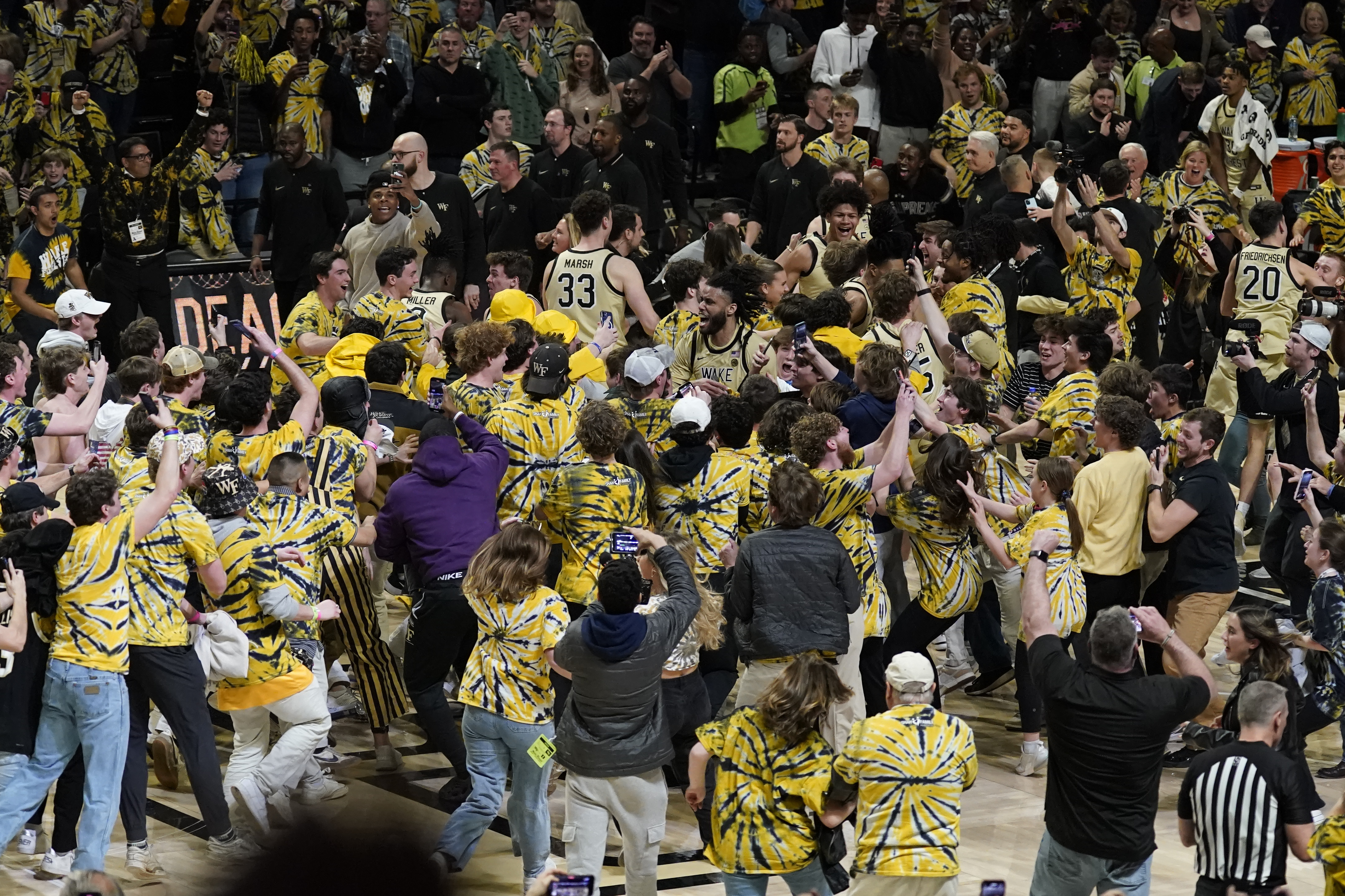 Fans storm the court as they celebrate with Wake Forest players after Wake Forest defeated Duke in an NCAA college basketball game in Winston-Salem, N.C., Saturday, Feb. 24, 2024. 