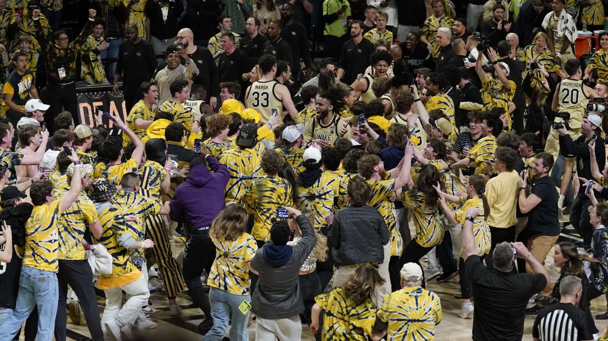 Fans storm the court as they celebrate with Wake Forest players after Wake Forest defeated Duke in an NCAA college basketball game in Winston-Salem, N.C., Saturday, Feb. 24, 2024.