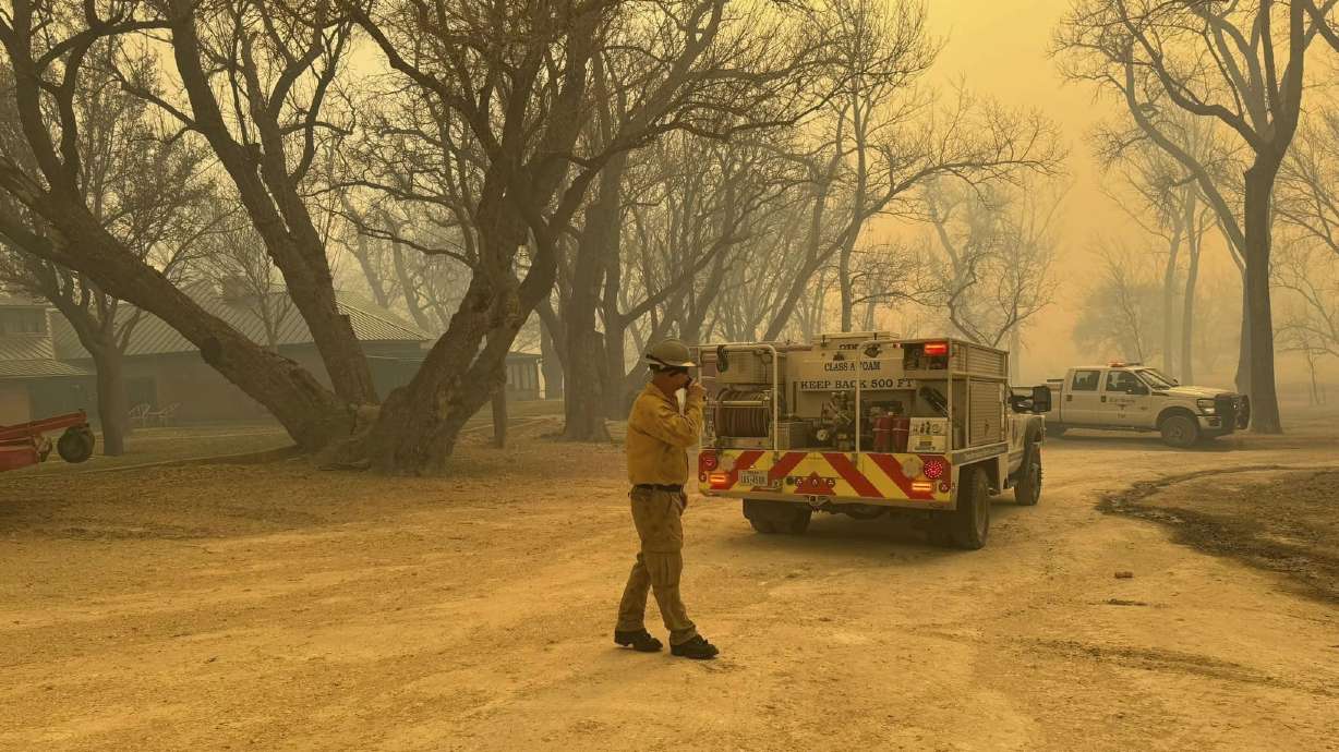 Flower Mound firefighters respond to a fire in the Texas Panhandle, Tuesday. A rapidly widening Texas wildfire doubled in size Tuesday and prompted evacuation orders in at least one small town.