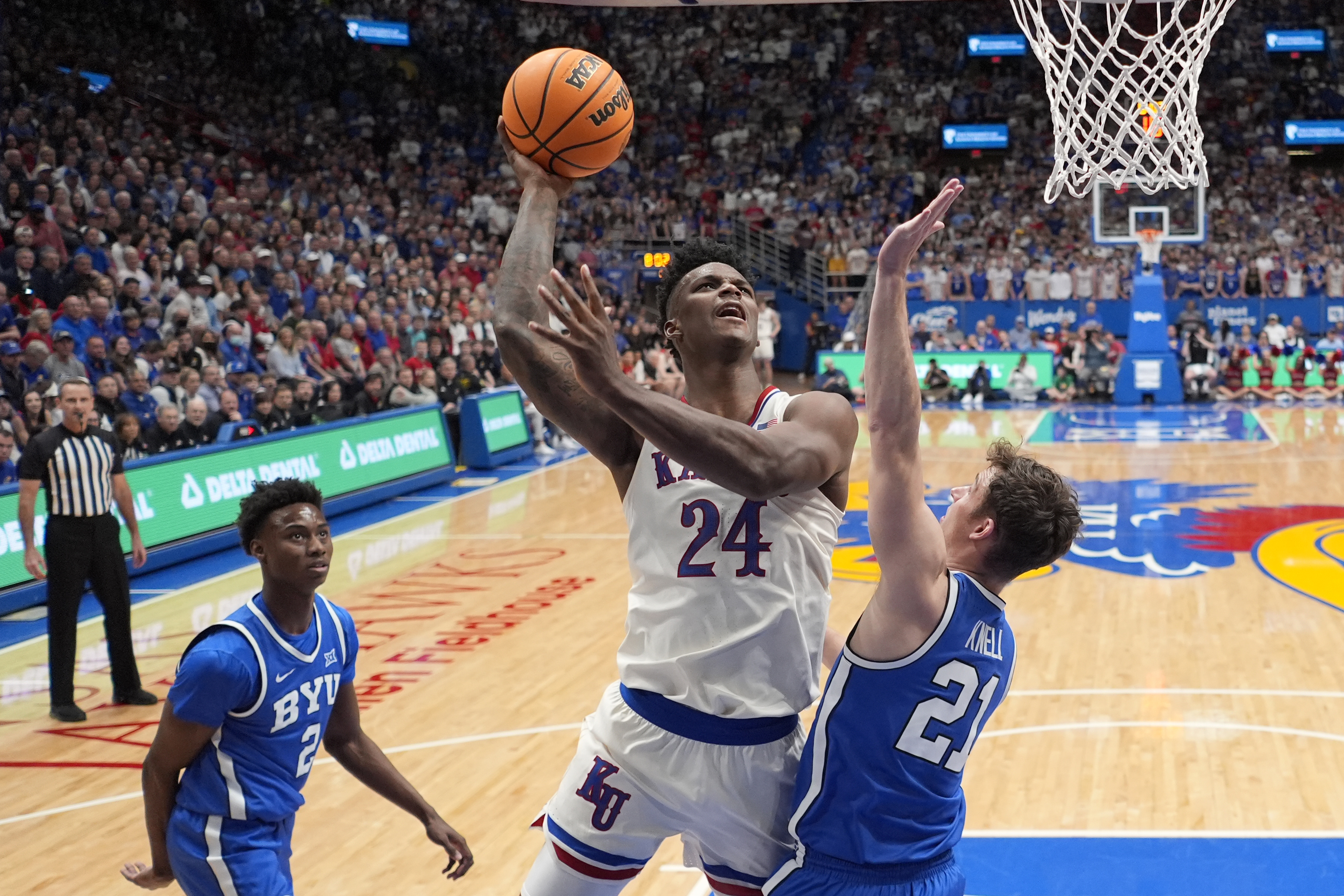 Kansas forward K.J. Adams Jr. (24) shoots over BYU guard Trevin Knell (21) during the first half of an NCAA college basketball game Tuesday, Feb. 27, 2024, in Lawrence, Kan.