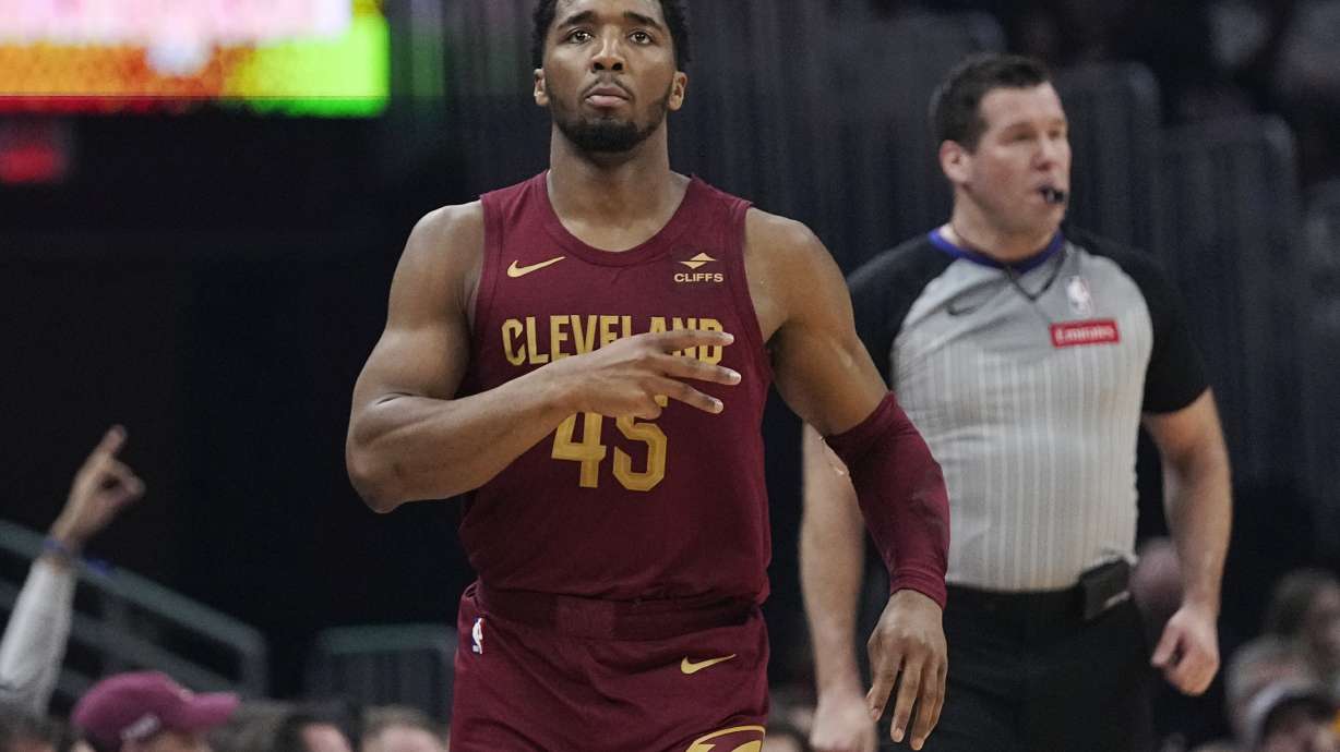 Cleveland Cavaliers guard Donovan Mitchell (45) gestures after a 3-point basket against the Dallas Mavericks during the first half of an NBA basketball game Tuesday, Feb. 27, 2024, in Cleveland.