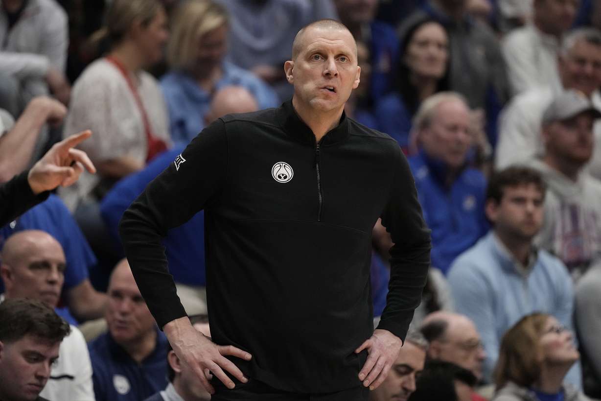 BYU head coach Mark Pope watches during the first half of an NCAA college basketball game against Kansas Tuesday, Feb. 27, 2024, in Lawrence, Kan.