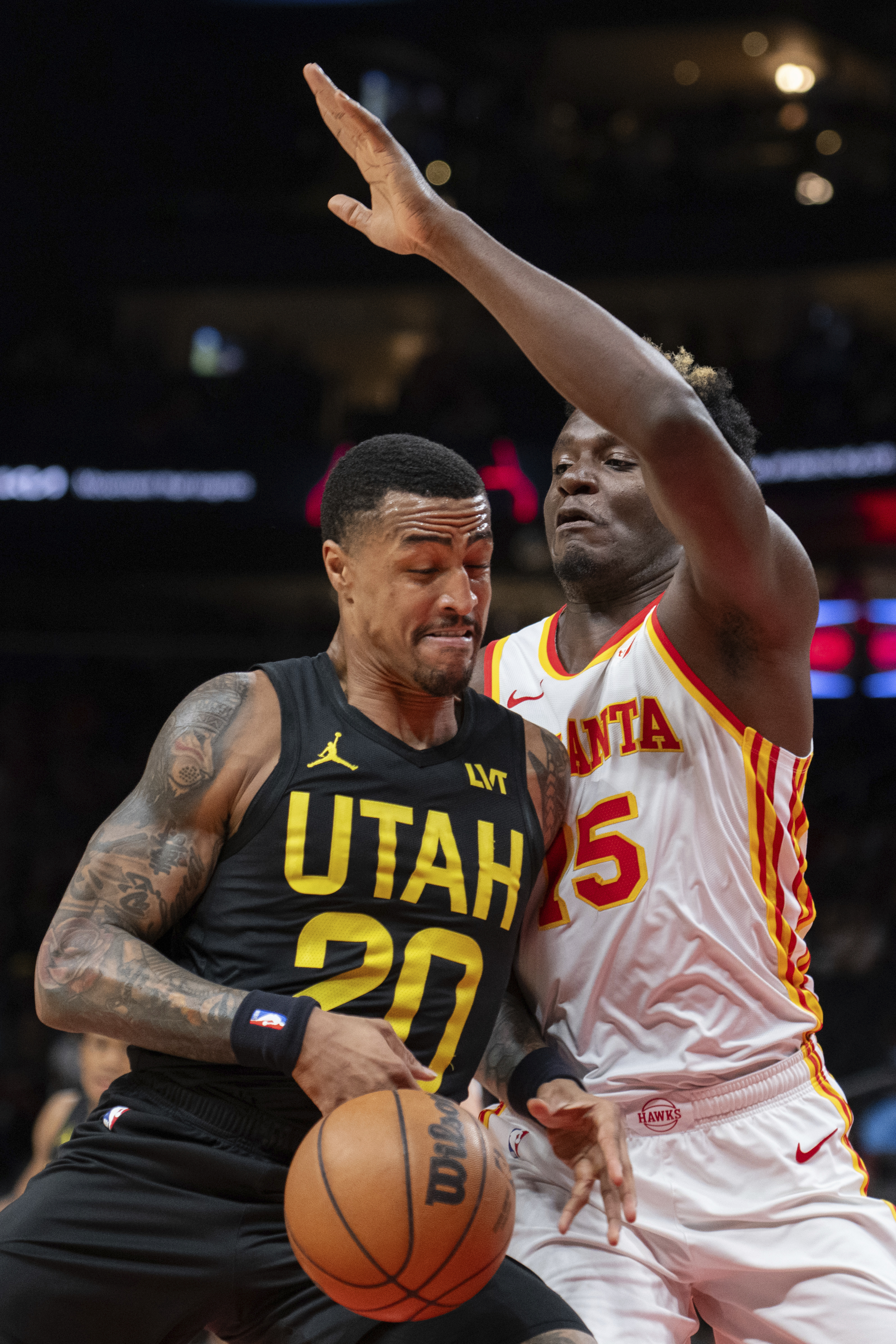 Utah Jazz forward John Collins (20) drives against Atlanta Hawks center Clint Capela (15) during the first half of an NBA basketball game Tuesday, Feb. 27, 2024, in Atlanta.