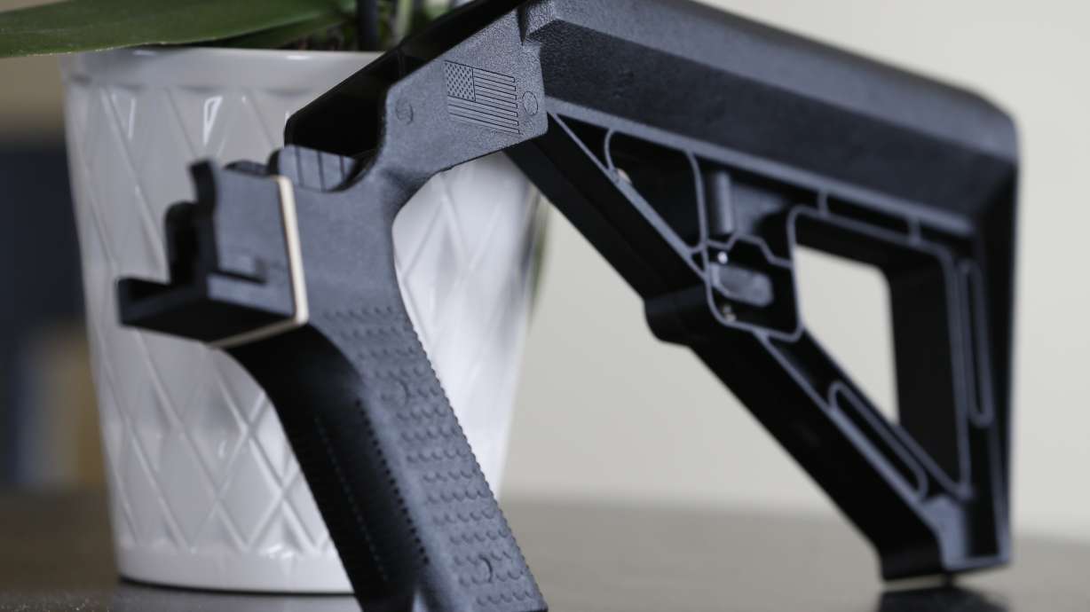 A bump stock is displayed in Harrisonburg, Va., on March 15, 2019. The Supreme Court appears torn about a challenge to a Trump-era ban on bump stocks.