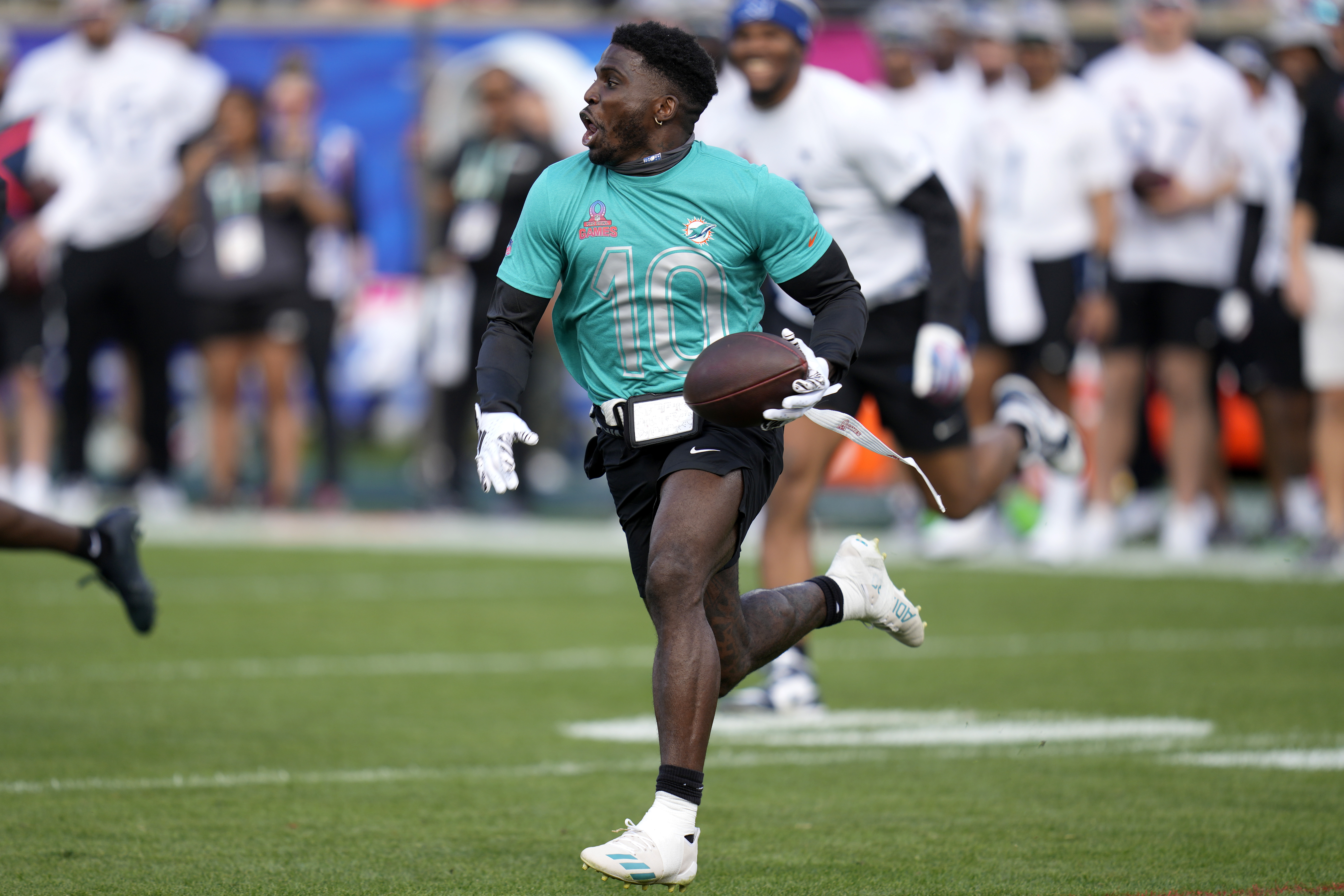 AFC wide receiver Tyreek Hill, of the Miami Dolphins, runs after the catch during the flag football event at the NFL Pro Bowl football game, Sunday, Feb. 4, 2024, in Orlando. 