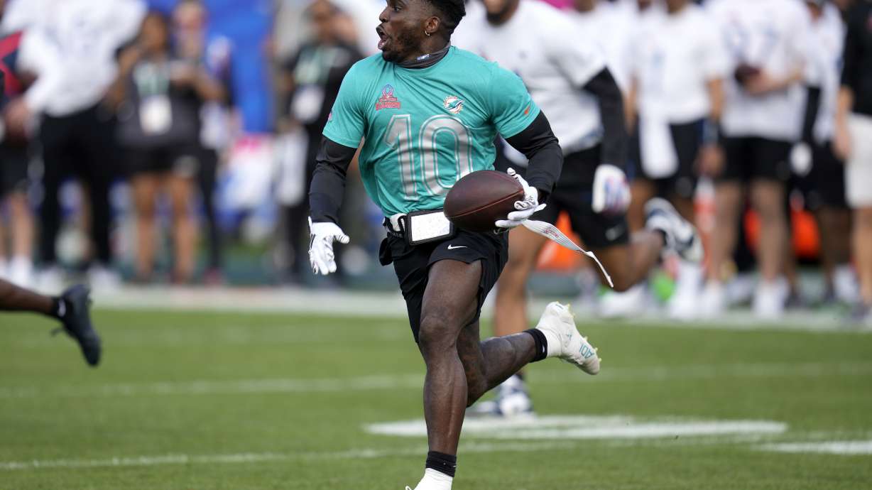 AFC wide receiver Tyreek Hill, of the Miami Dolphins, runs after the catch during the flag football event at the NFL Pro Bowl football game, Sunday, Feb. 4, 2024, in Orlando.