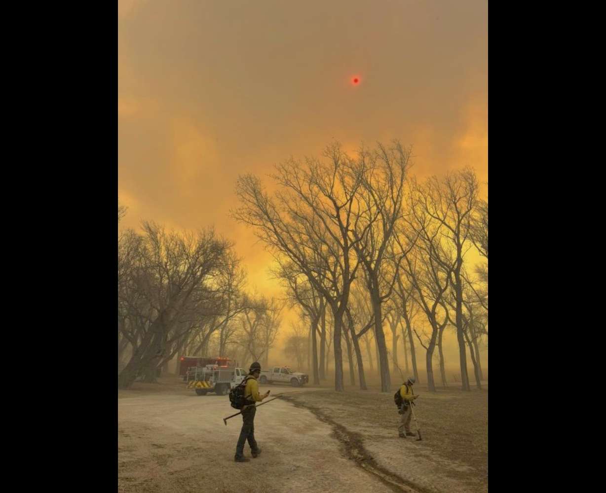 Flower Mound firefighters respond to a fire in the Texas Panhandle, Tuesday. A rapidly widening Texas wildfire doubled in size Tuesday and prompted evacuation orders in at least one small town.