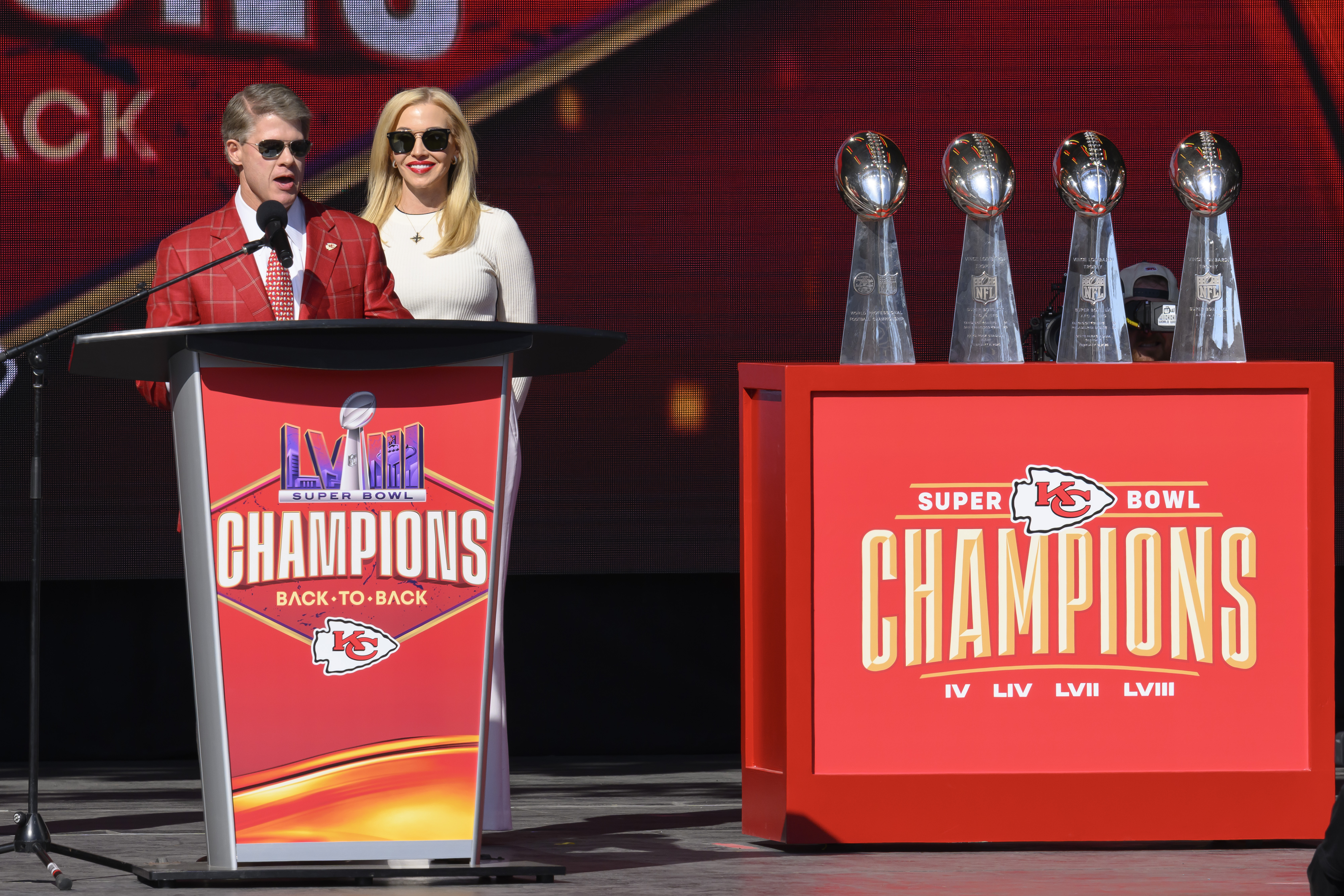 Kansas City Chiefs chairman and CEO Clark Hunt, with his wife Tavia Shackels Hunt, speak to the crowd during their victory rally in Kansas City, Mo., Wednesday, Feb. 14, 2024. The Chiefs defeated the San Francisco 49ers Sunday in the NFL Super Bowl 58 football game. 