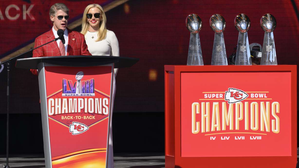 Kansas City Chiefs chairman and CEO Clark Hunt, with his wife Tavia Shackels Hunt, speak to the crowd during their victory rally in Kansas City, Mo., Wednesday, Feb. 14, 2024. The Chiefs defeated the San Francisco 49ers Sunday in the NFL Super Bowl 58 football game.