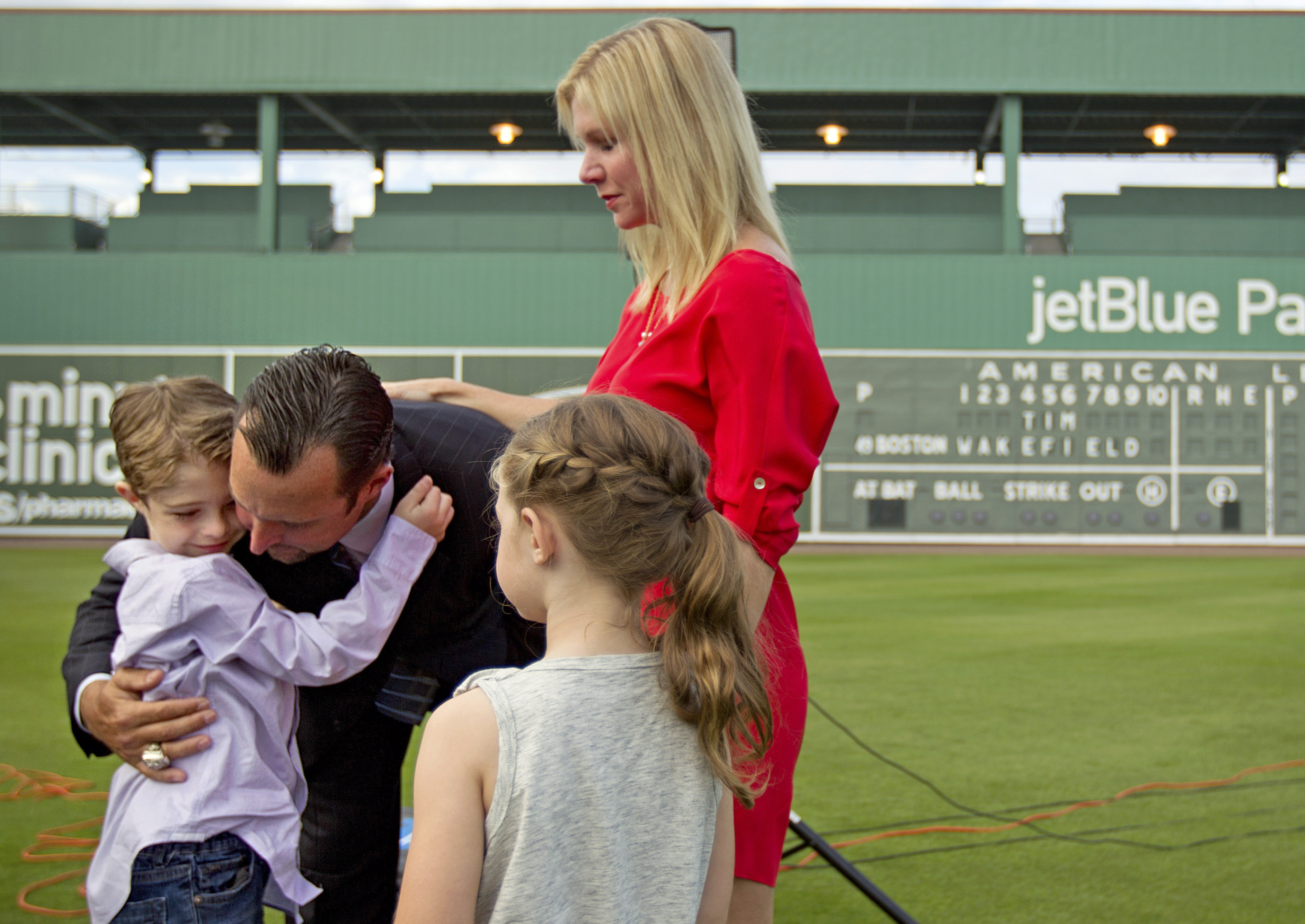 FILE - Boston Red Sox pitcher Tim Wakefield, center left, hugs his son, Trevor, 7, as his wife, Stacy, right, and daughter, Brianna, 6, look on after Wakefield announced his retirement from baseball during a news conference, Friday, Feb. 17, 2012, in Fort Myers, Fla. Stacy Wakefield, the widow of former Boston Red Sox pitcher and two-time World Series champion Tim Wakefield, has died. Wakefield's family said in a statement released through the Red Sox that she died Wednesday, Feb. 28, 2024 at her Massachusetts home, less than five months after her husband died at the age of 57. 