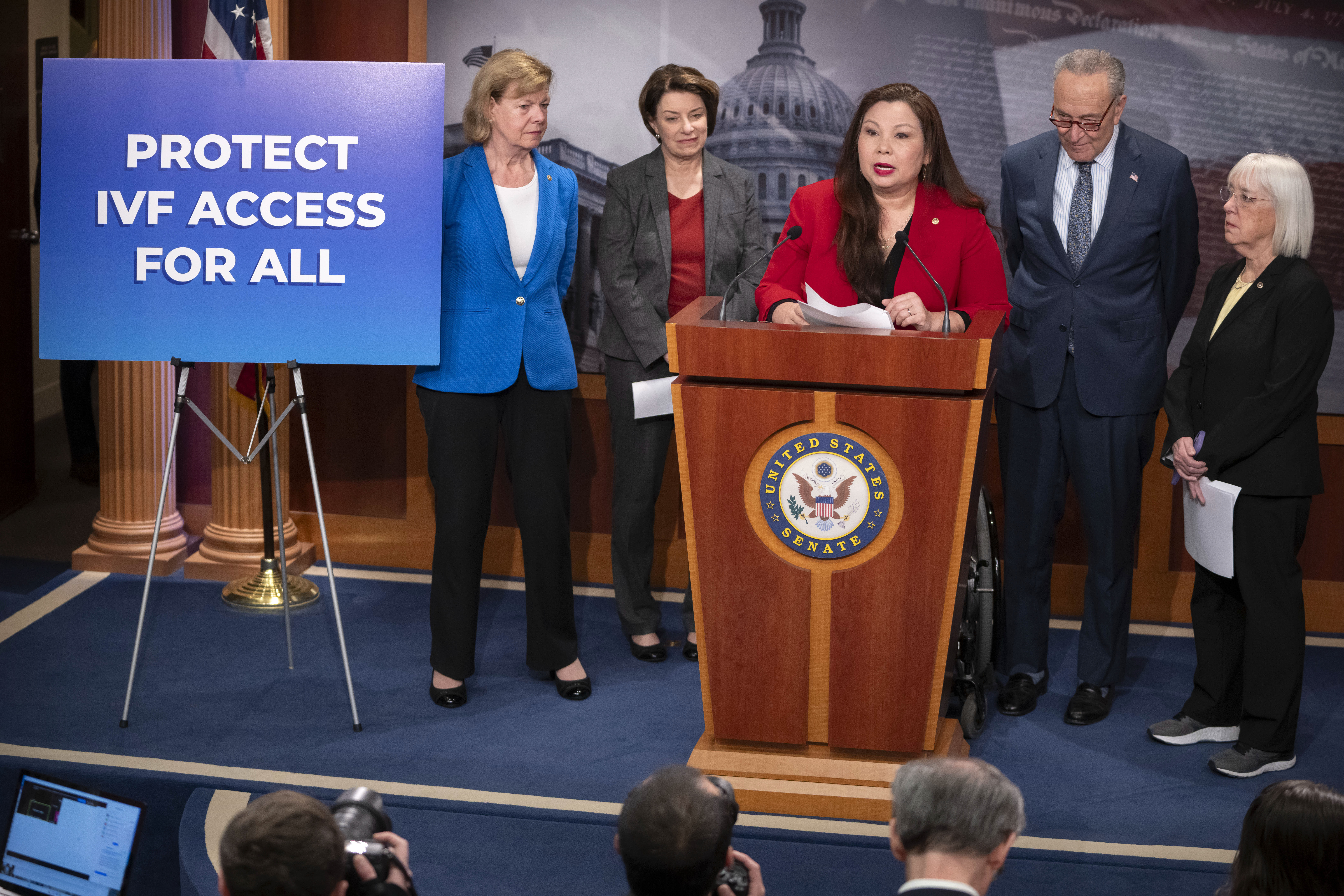 Sen. Tammy Duckworth, D-Ill., center, speaks about a bill to establish federal protections for IVF as, from left, Sen. Tammy Baldwin, D-Wis., Sen. Amy Klobuchar, D-Minn., Senate Majority Leader Chuck Schumer of N.Y., and Sen. Patty Murray, D-Wash., listen during a press event on Capitol Hill, Tuesday in Washington. 