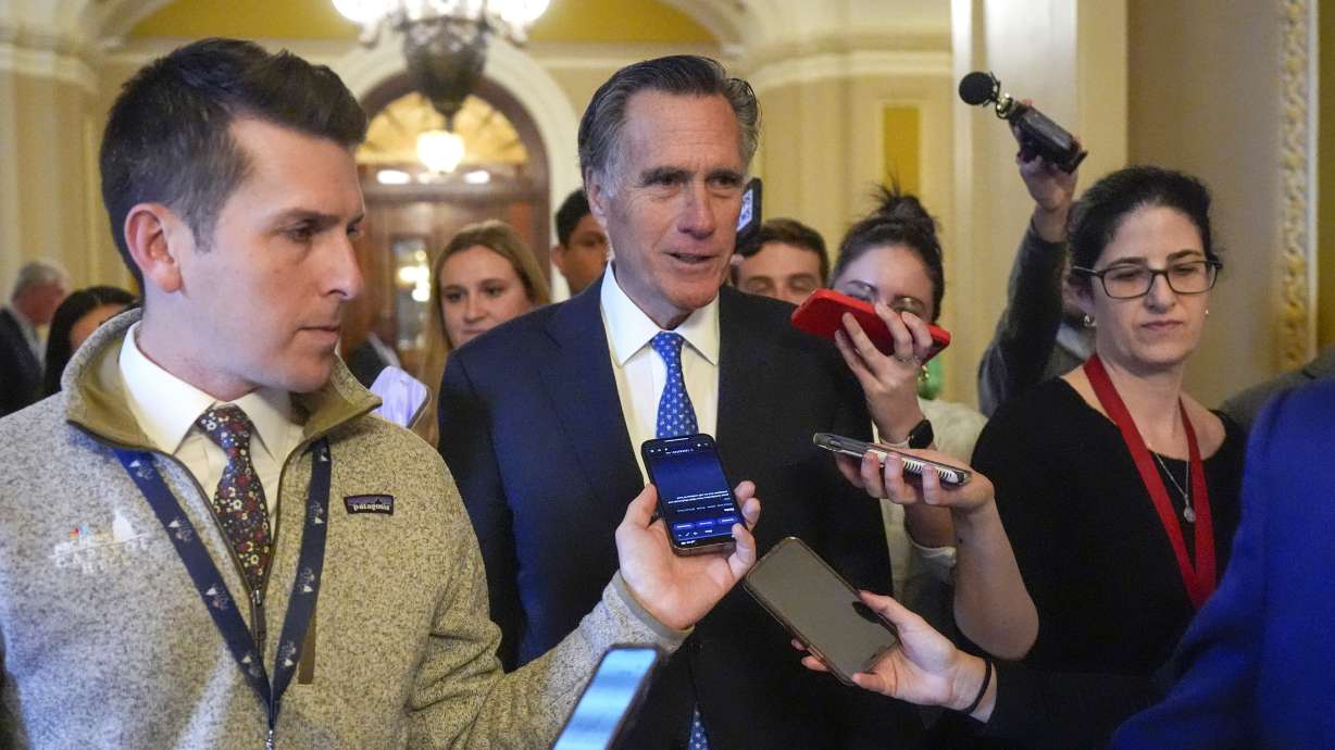 Sen. Mitt Romney, R-Utah, speaks with members of the media as he walks, Feb. 28, at the Capitol in Washington. The senator and several colleagues on Tuesday proposed a framework for the federal government to mitigate risks posed by artificial intelligence.
