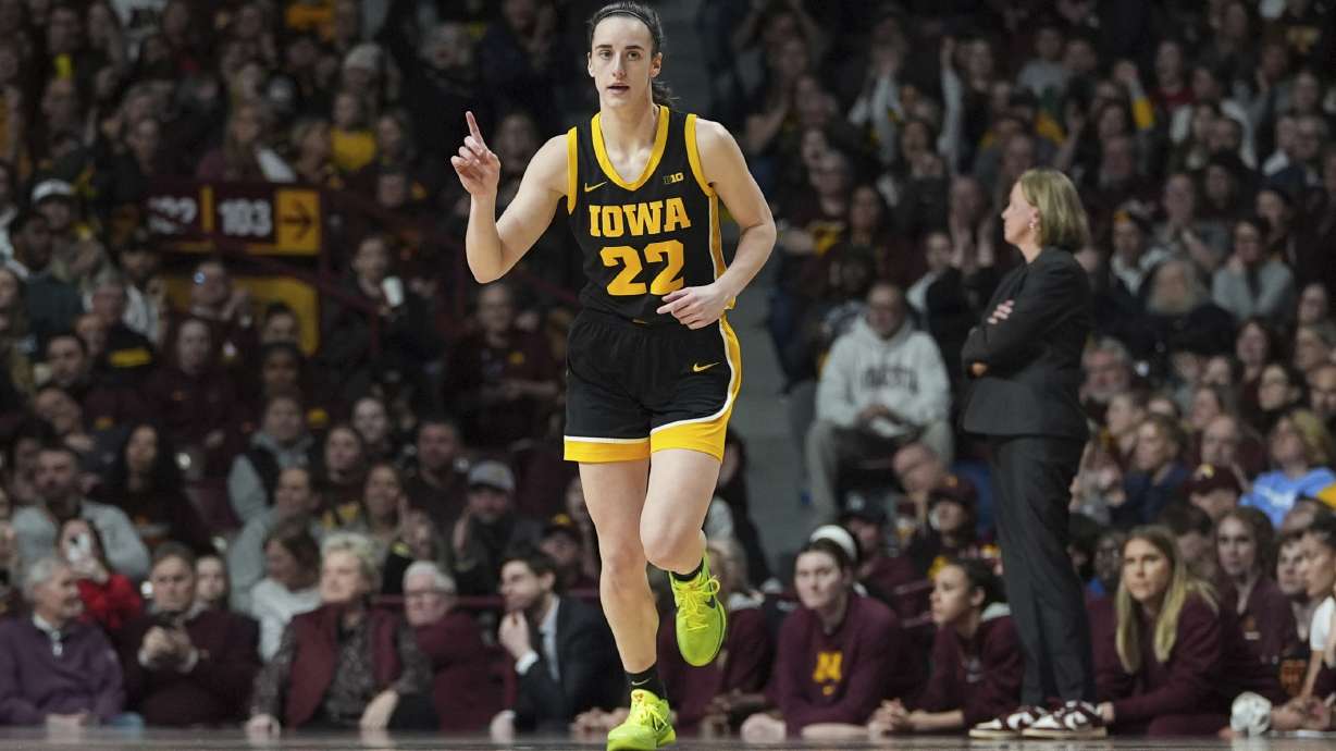 Iowa guard Caitlin Clark (22) points after an Iowa basket scored during the first half of an NCAA college basketball game against Minnesota, Wednesday, Feb. 28, 2024, in Minneapolis.