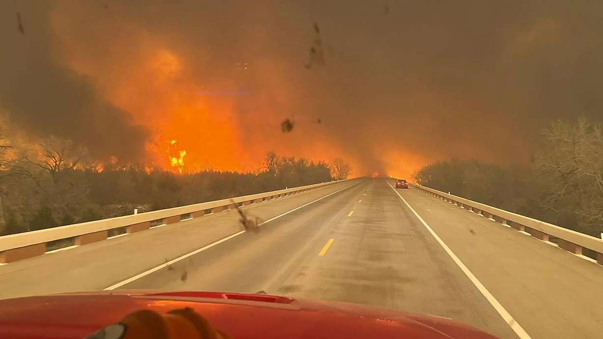 A fast-moving wildfire burning through the Texas Panhandle grew into the second-largest blaze in state history Thursday, forcing evacuations and triggering power outages as firefighters struggled to contain the widening flames.