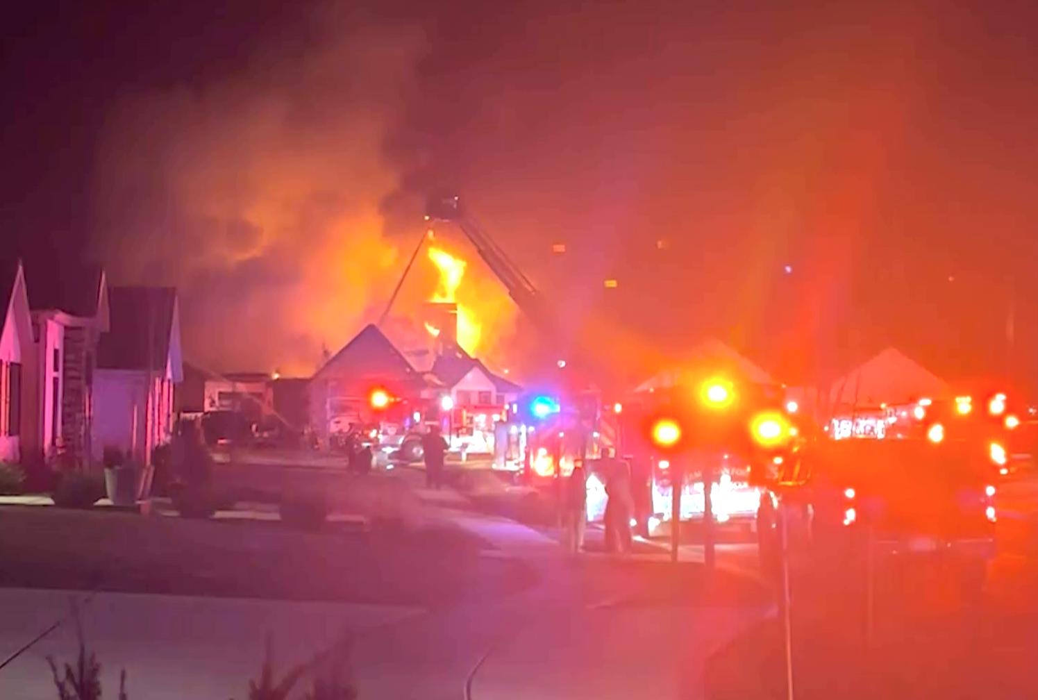 Fire crews work to extinguish a house fire near 18 E. 1460 North in Lehi where early Thursday. Investigators say the house is a total loss, but the people inside got out OK.