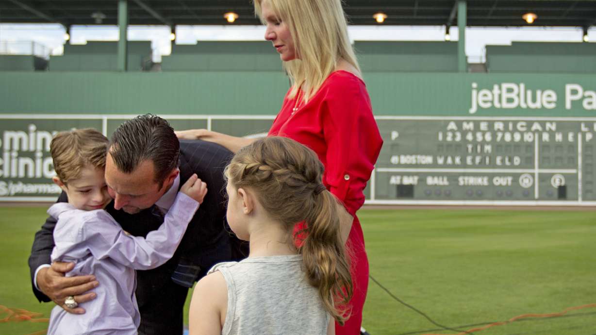 FILE - Boston Red Sox pitcher Tim Wakefield, center left, hugs his son, Trevor, 7, as his wife, Stacy, right, and daughter, Brianna, 6, look on after Wakefield announced his retirement from baseball during a news conference, Friday, Feb. 17, 2012, in Fort Myers, Fla. Stacy Wakefield, the widow of former Boston Red Sox pitcher and two-time World Series champion Tim Wakefield, has died. Wakefield's family said in a statement released through the Red Sox that she died Wednesday, Feb. 28, 2024 at her Massachusetts home, less than five months after her husband died at the age of 57.