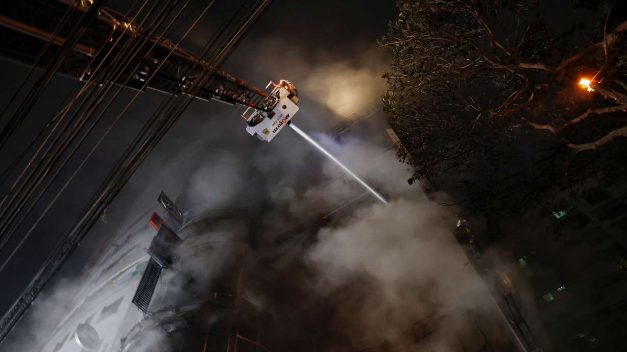 Firefighters spray water to douse a fire that broke out in a multi-story building in Dhaka, Bangladesh, Thursday. The fire killed at least 43 people and injured dozens, the country's health minister said.