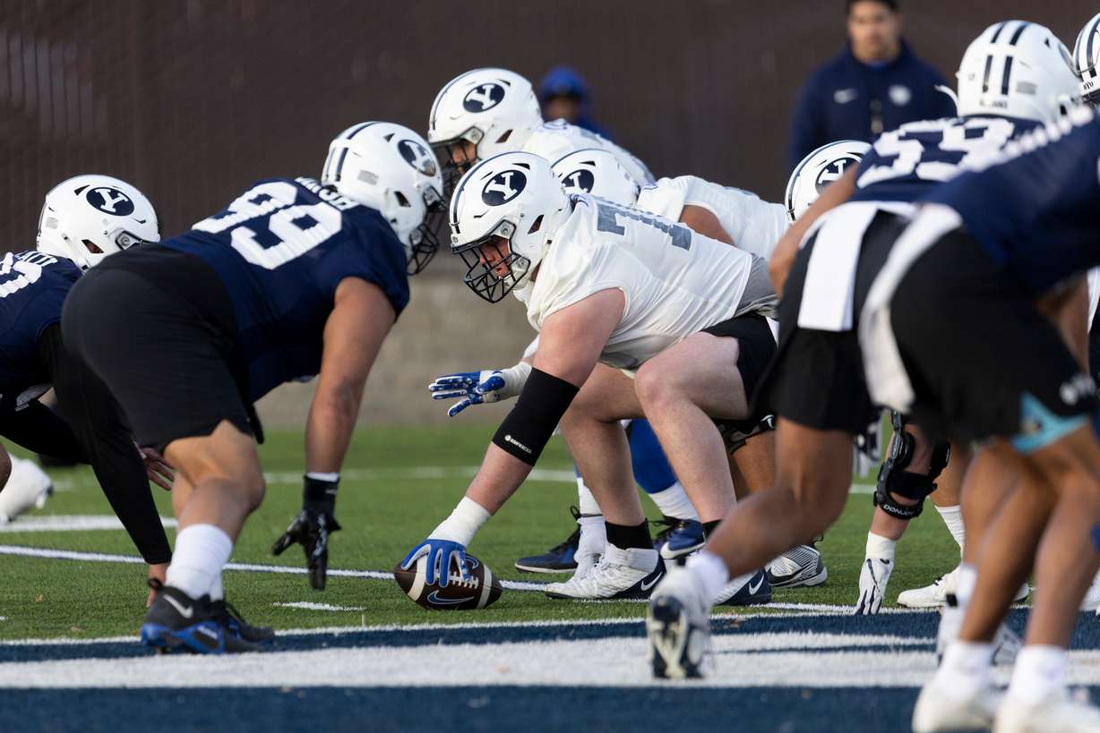 BYU offensive lineman Connor Pay prepares to snap the ball during a practice on the SAB outdoor practice fields at the start of spring camp in Provo on Thursday, Feb. 29, 2024.