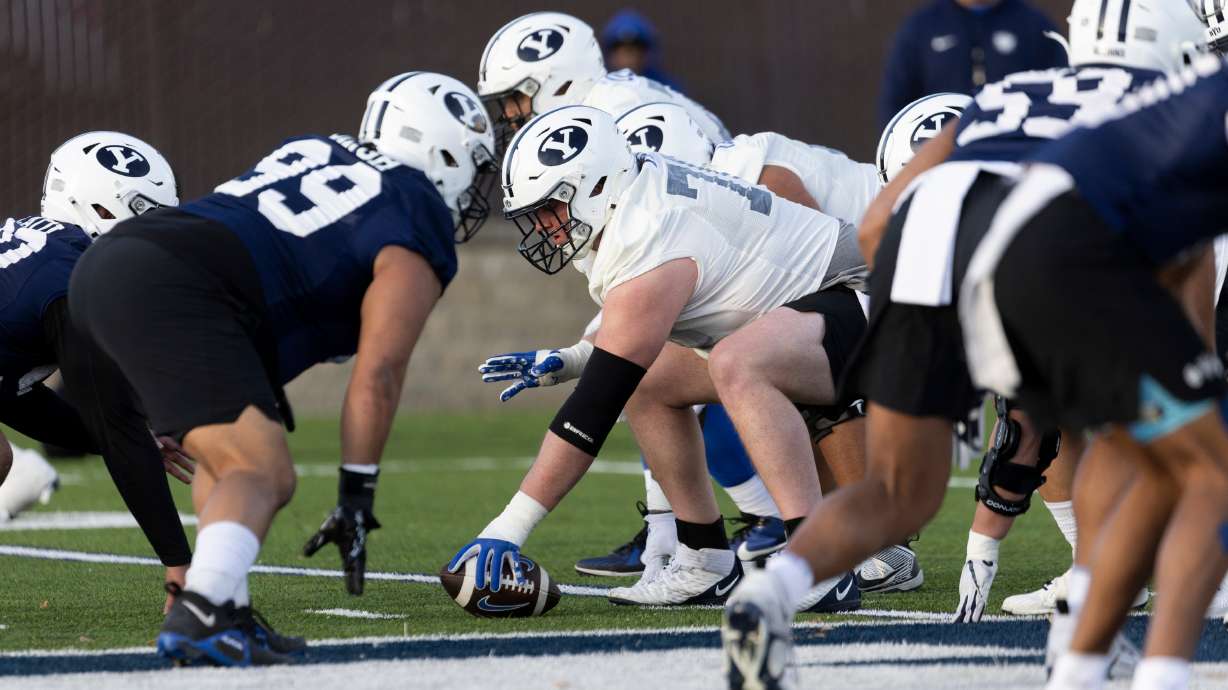 BYU offensive lineman Connor Pay prepares to snap the ball during a practice on the SAB outdoor practice fields at the start of spring camp in Provo on Thursday, Feb. 29, 2024.