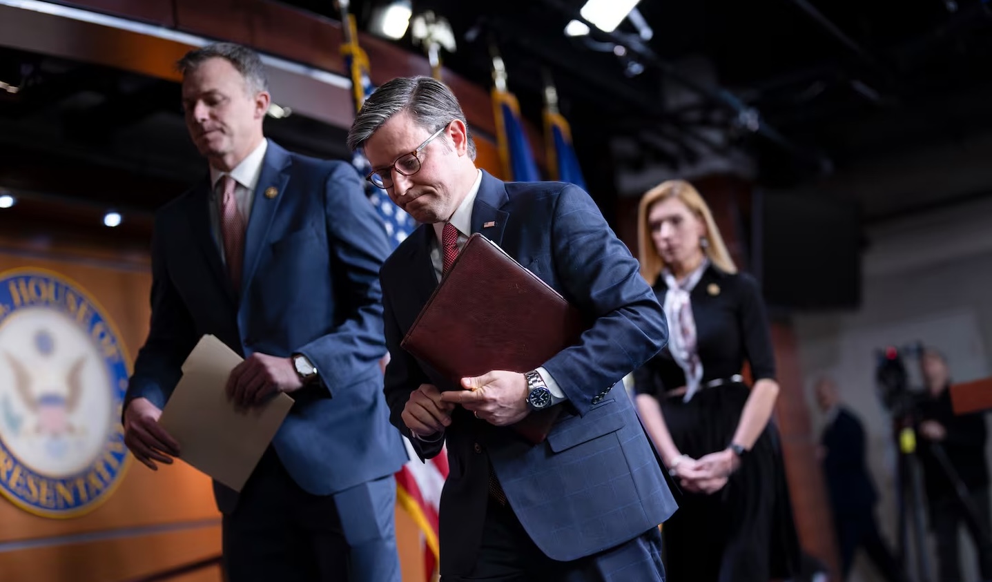 House Speaker Mike Johnson, R-La., after a news conference, with Rep. Blake Moore, R-Utah, left, and Rep. Beth Van Duyne, R-Texas, at the Capitol in Washington on Thursday. The House approved a stopgap bill to avert a government shutdown.