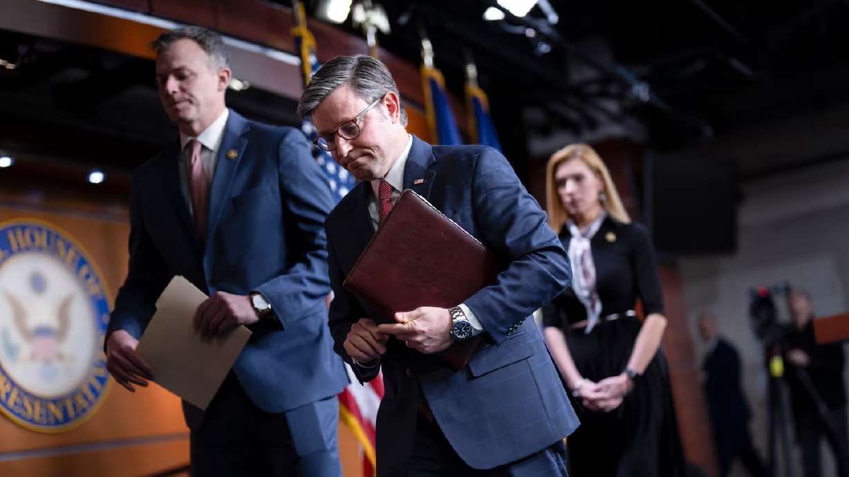 House Speaker Mike Johnson, R-La., after a news conference, with Rep. Blake Moore, R-Utah, left, and Rep. Beth Van Duyne, R-Texas, at the Capitol in Washington on Thursday. The House approved a stopgap bill to avert a government shutdown.
