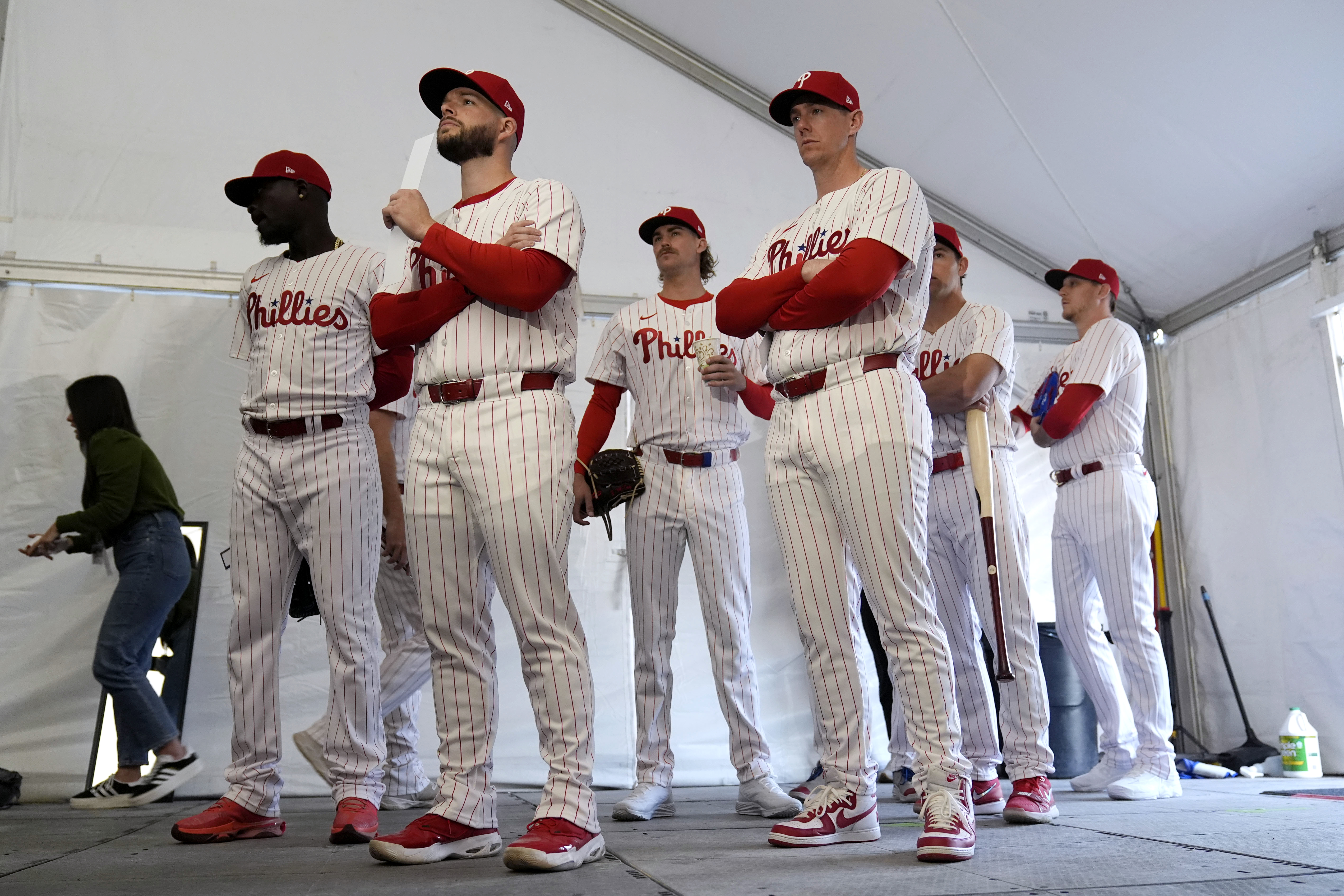 FILE - Philadelphia Phillies players wait to have their photo taken during a baseball spring training photo day Thursday, Feb. 22, 2024, in Clearwater, Fla. Baseball players’ association head Tony Clark is hopeful 2024 uniforms will soon be altered following complaints by his members. The uniforms designed by Nike and manufactured by Fanatics have been criticized by players for pants that are somewhat see through and for lettering, sleeve emblems and numbering that are less bulky and apparently smaller.
