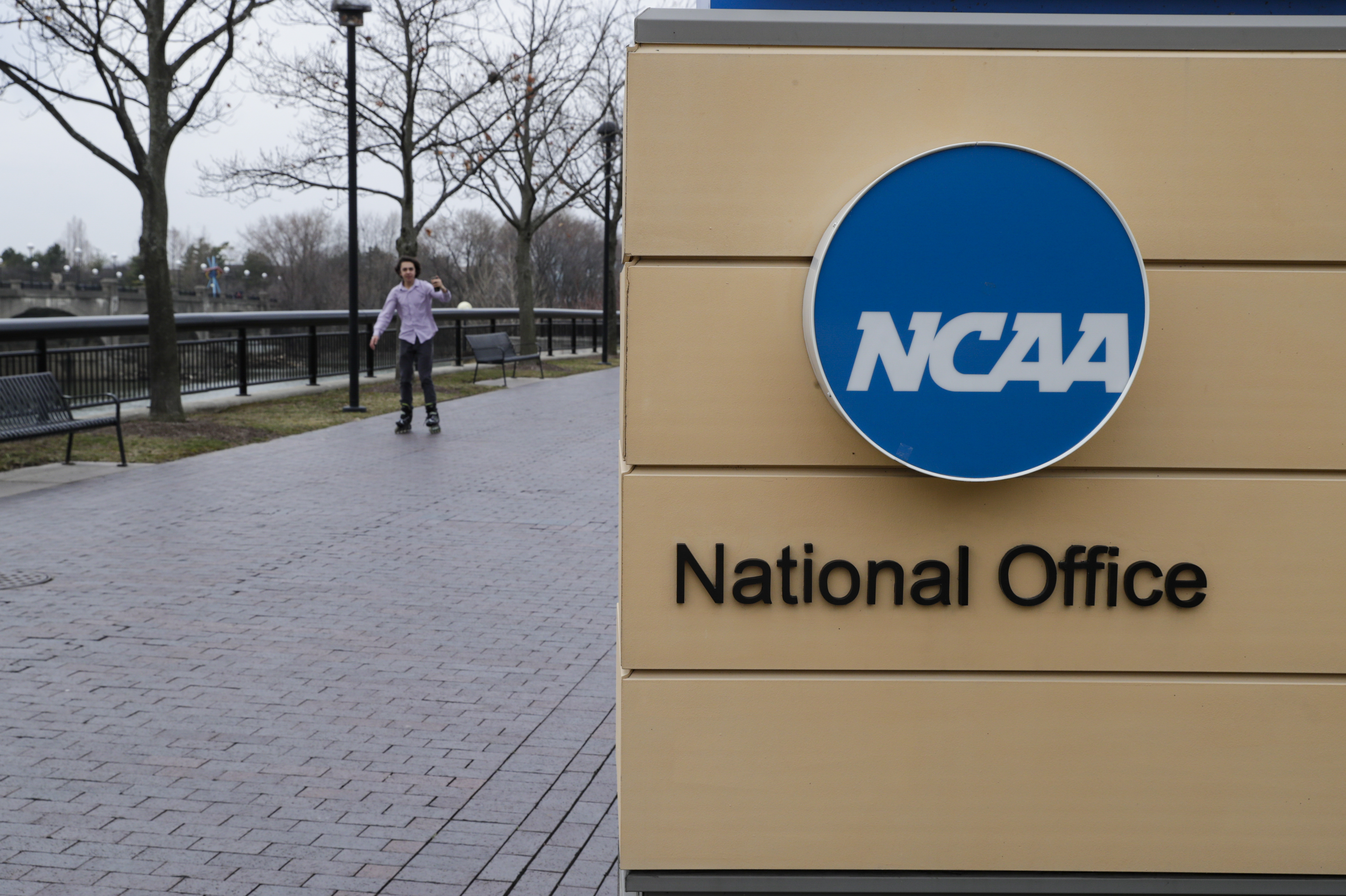 FILE - NCAA signage outside the headquarters in Indianapolis, Thursday, March 12, 2020. Forced into yet another courtroom to defend its amateur model of athletics, the NCAA argued that shelving its rules against name, image and likeness compensation being offered to recruits would make an already difficult situation across the country even more chaotic. 
