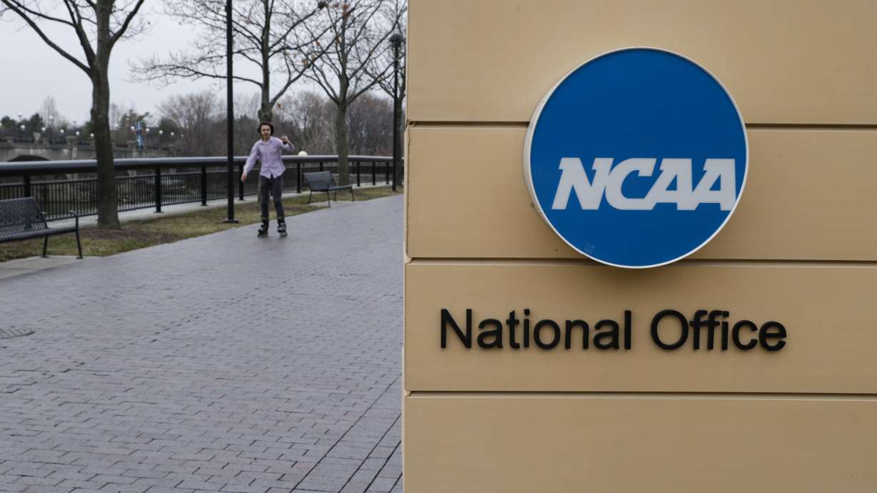 FILE - NCAA signage outside the headquarters in Indianapolis, Thursday, March 12, 2020. Forced into yet another courtroom to defend its amateur model of athletics, the NCAA argued that shelving its rules against name, image and likeness compensation being offered to recruits would make an already difficult situation across the country even more chaotic.